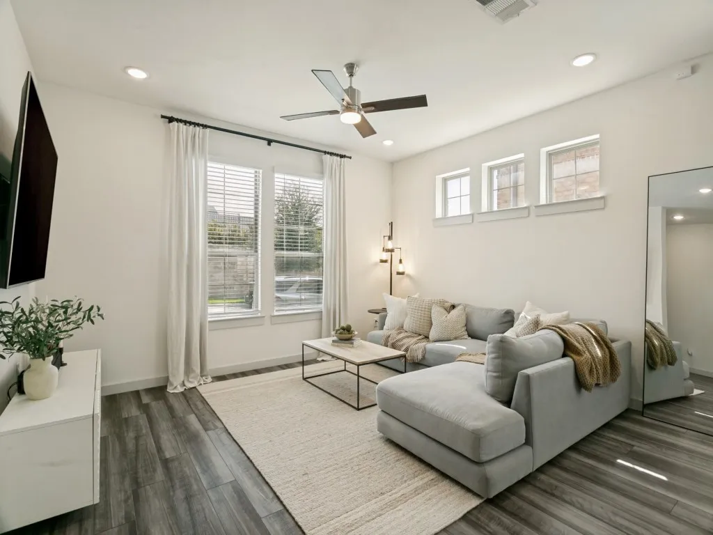 Wood-finish flooring throughout, recessed lighting, and a ceiling fan