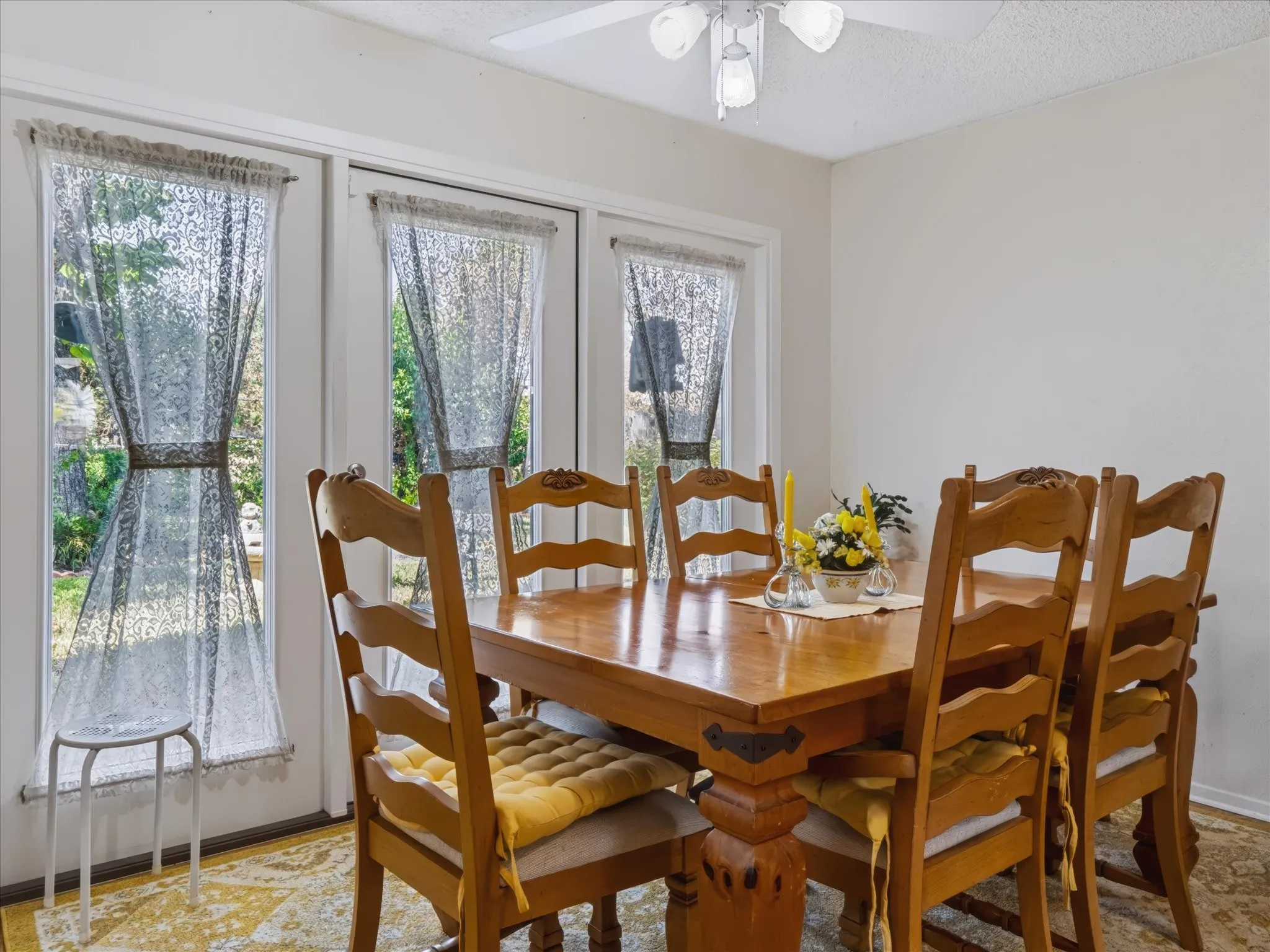 Triple French doors, white ceiling fan with integrated lighting