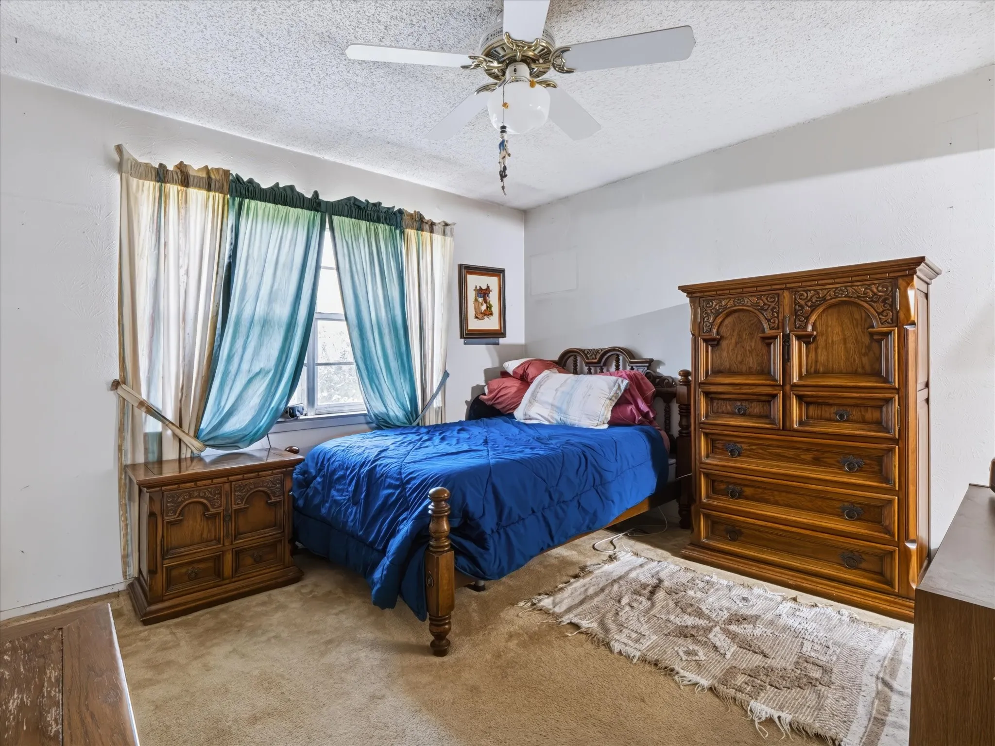 Room featuring a window, ceiling fan, and carpeted flooring