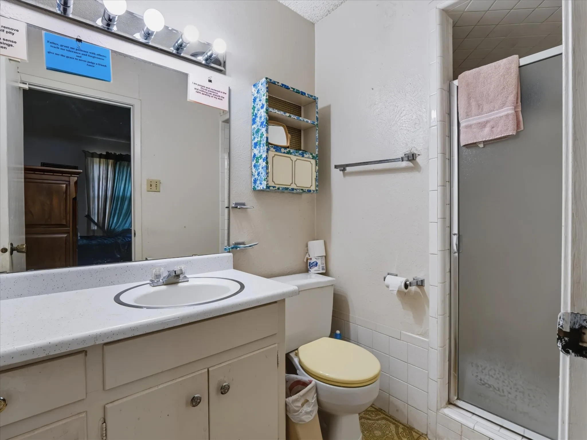Bathroom with a single vanity, integrated sink, and shower enclosure