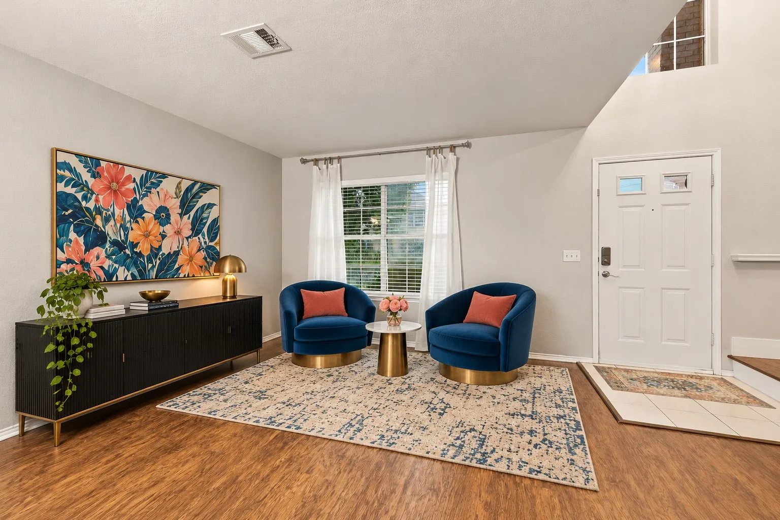 Virtually Staged Wood-finish flooring throughout, bright window with blinds, front entry door with transom window, and a high-pitched ceiling with upper window