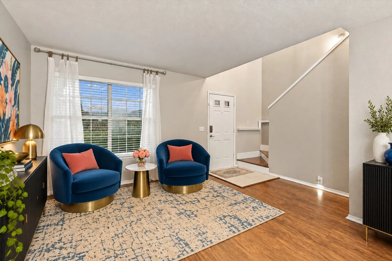 Virtually Staged Wood-finish flooring throughout, bright window with blinds, and a white front entry door with decorative glass inserts