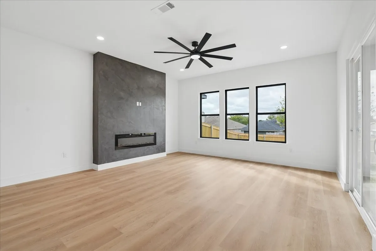 Wood-finish flooring, recessed lighting, and a modern ceiling fan