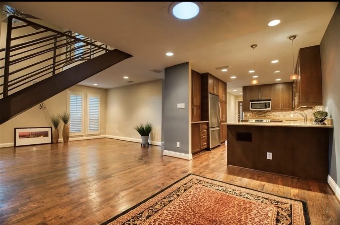 This dining room can also serve as an office if desired. Most recent  Tenant used it as Office space. This is the view from the dining room, looking at both the kitchen and the living area and staircase