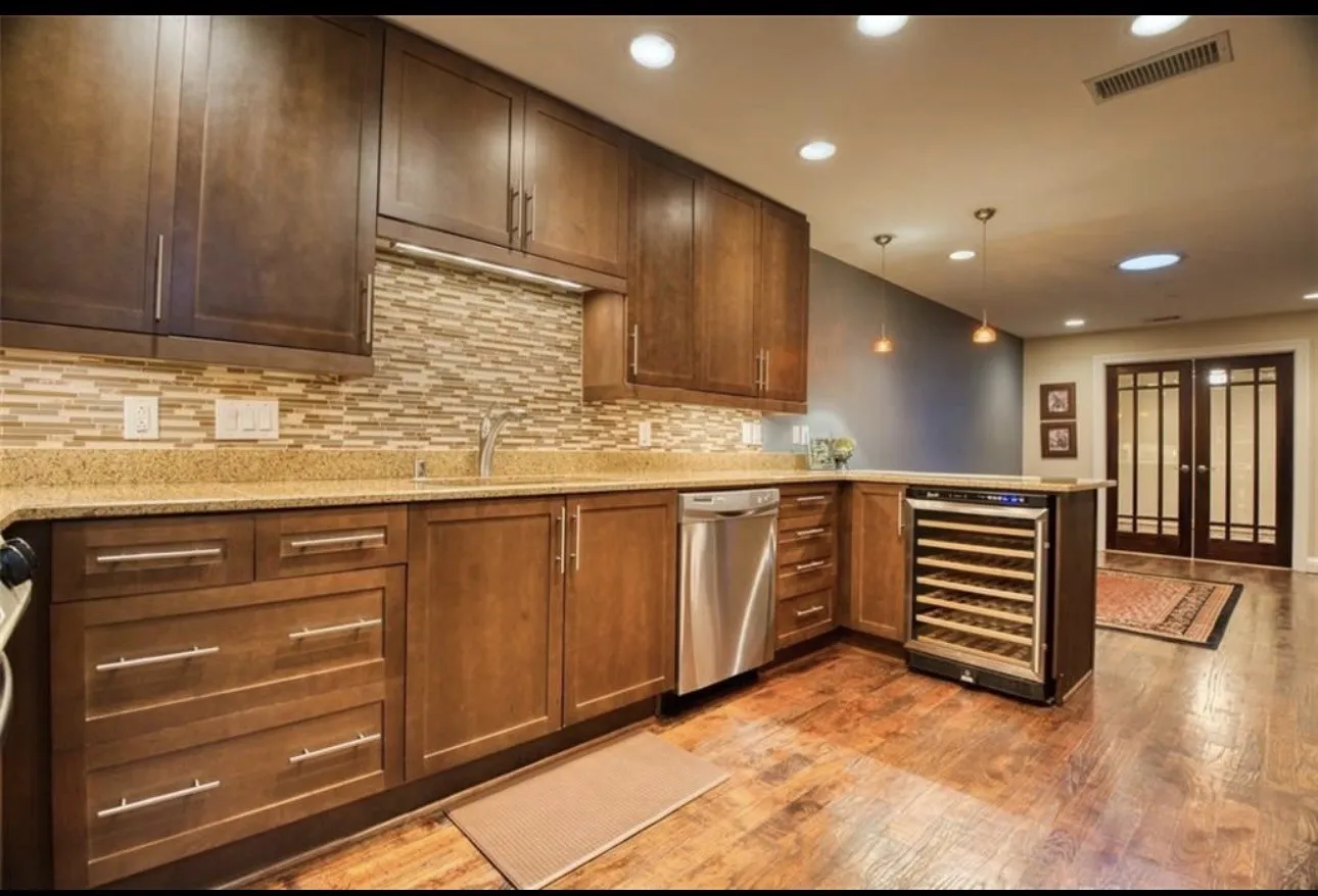 Absolutely Beautiful kitchen that was recently remodeled with wine cooler that also serves as a small counter bar. Cabinets go to the ceiling and recessed lighting.