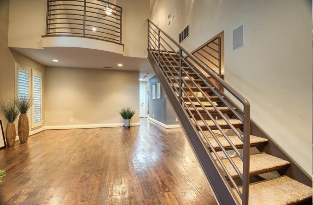 Sensationalism of view of the living room with the Juliette balcony from the primary suite overlooking. Note the open  staircase