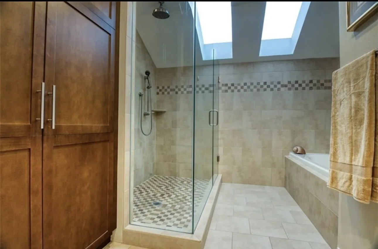 Phenomenal modern primary bath has a beautiful walk-in closet and extraordinary looking- glass walled  adjacent to bathtub. .Total luxurious feel