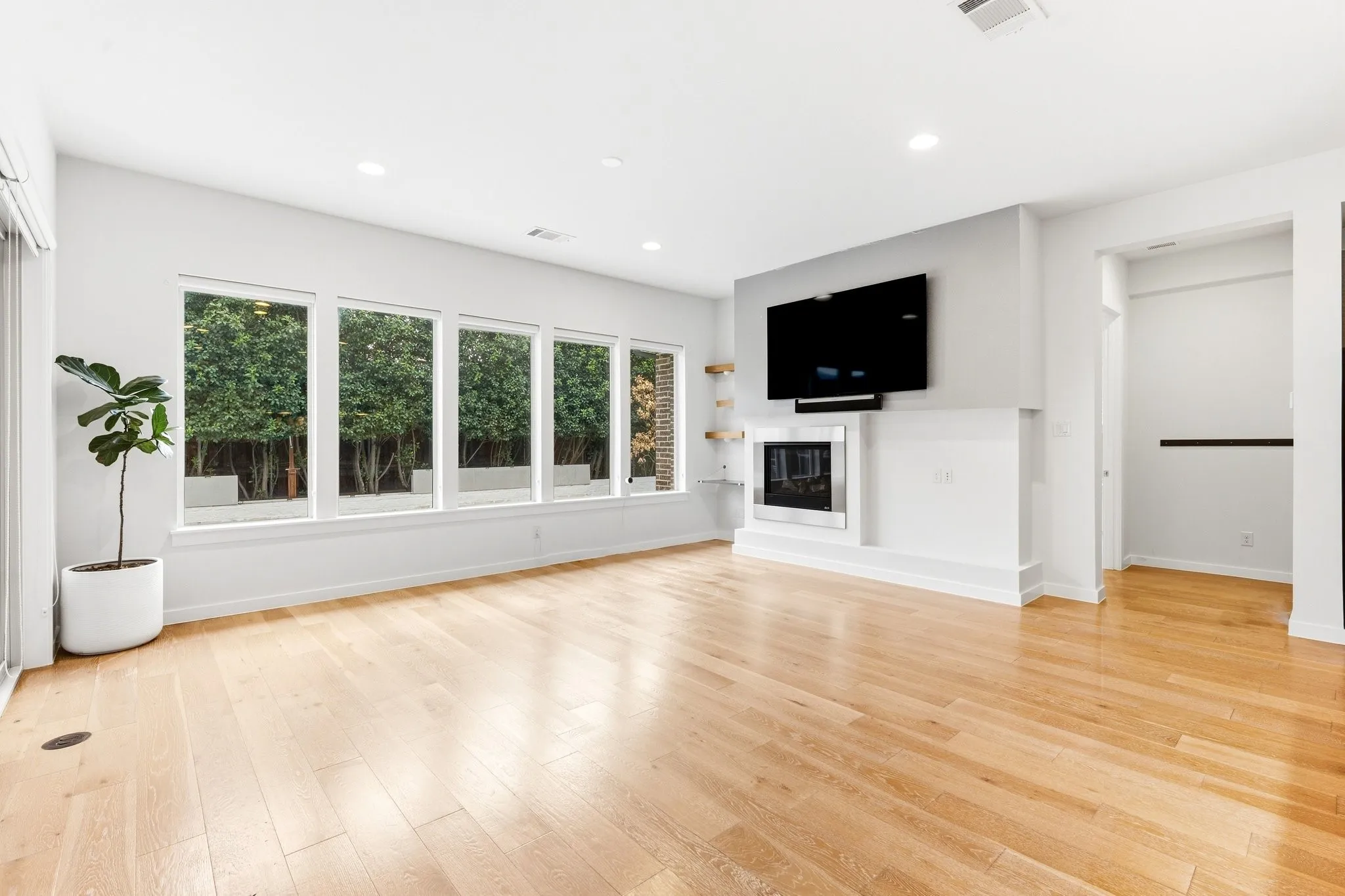 Main living room with panoramic pool views, clean lines, and effortless open layout