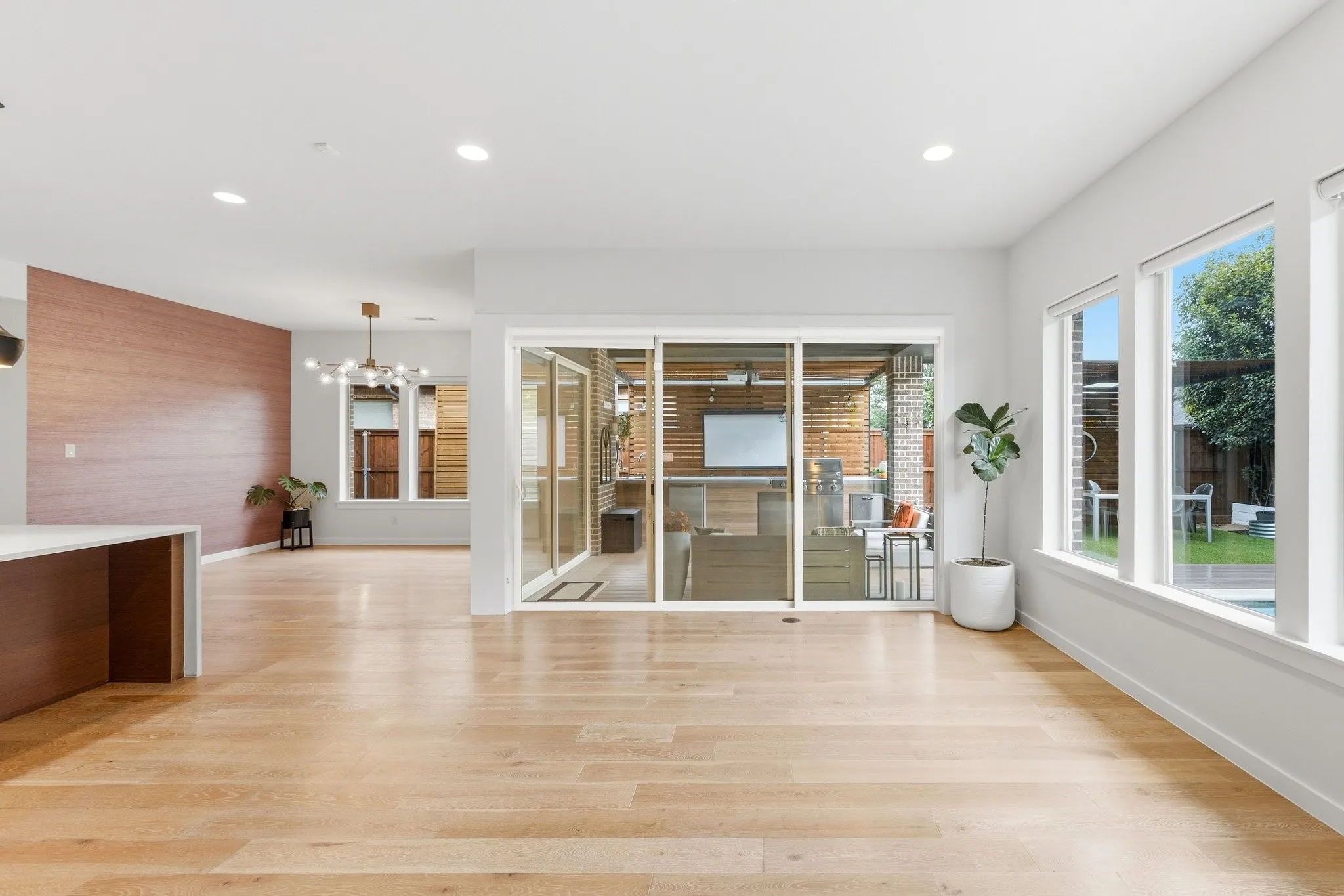 Walls of glass frame views of the resort style backyard and allow natural light to pour in throughout the day.