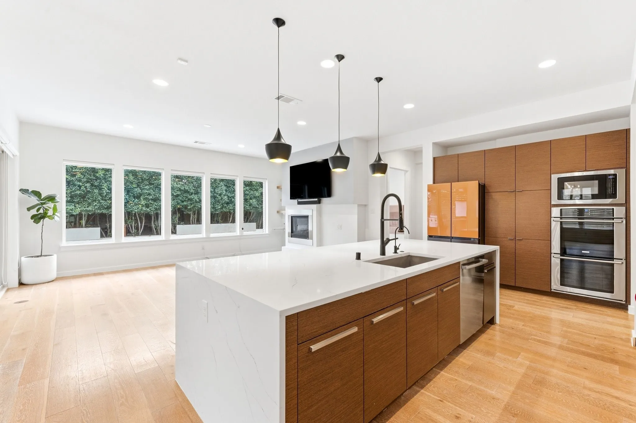 High-end kitchen layout seamlessly integrating cooking, dining, and living zones