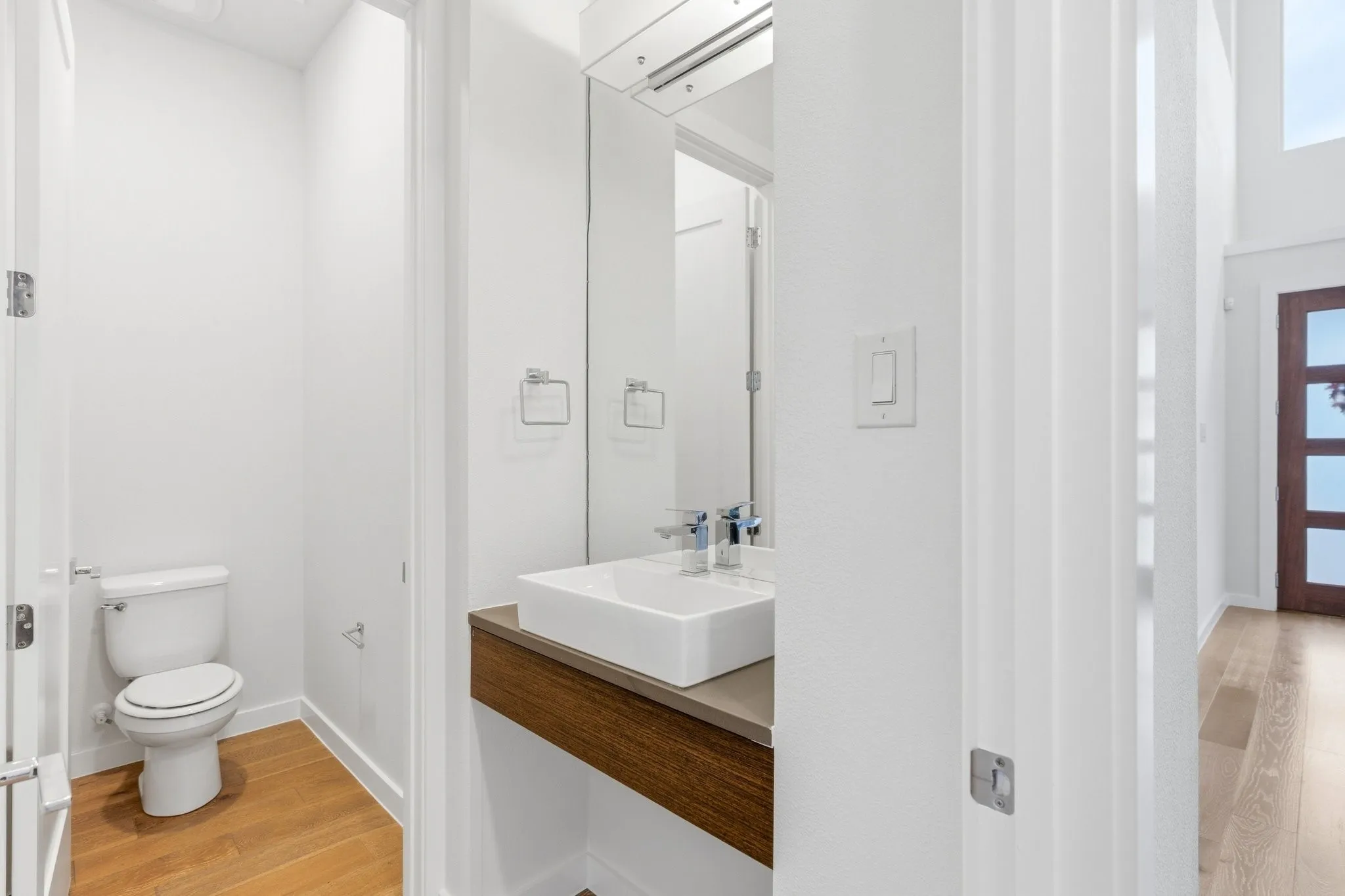 Convenient main-floor powder bath featuring modern finishes and sleek designer vanity.