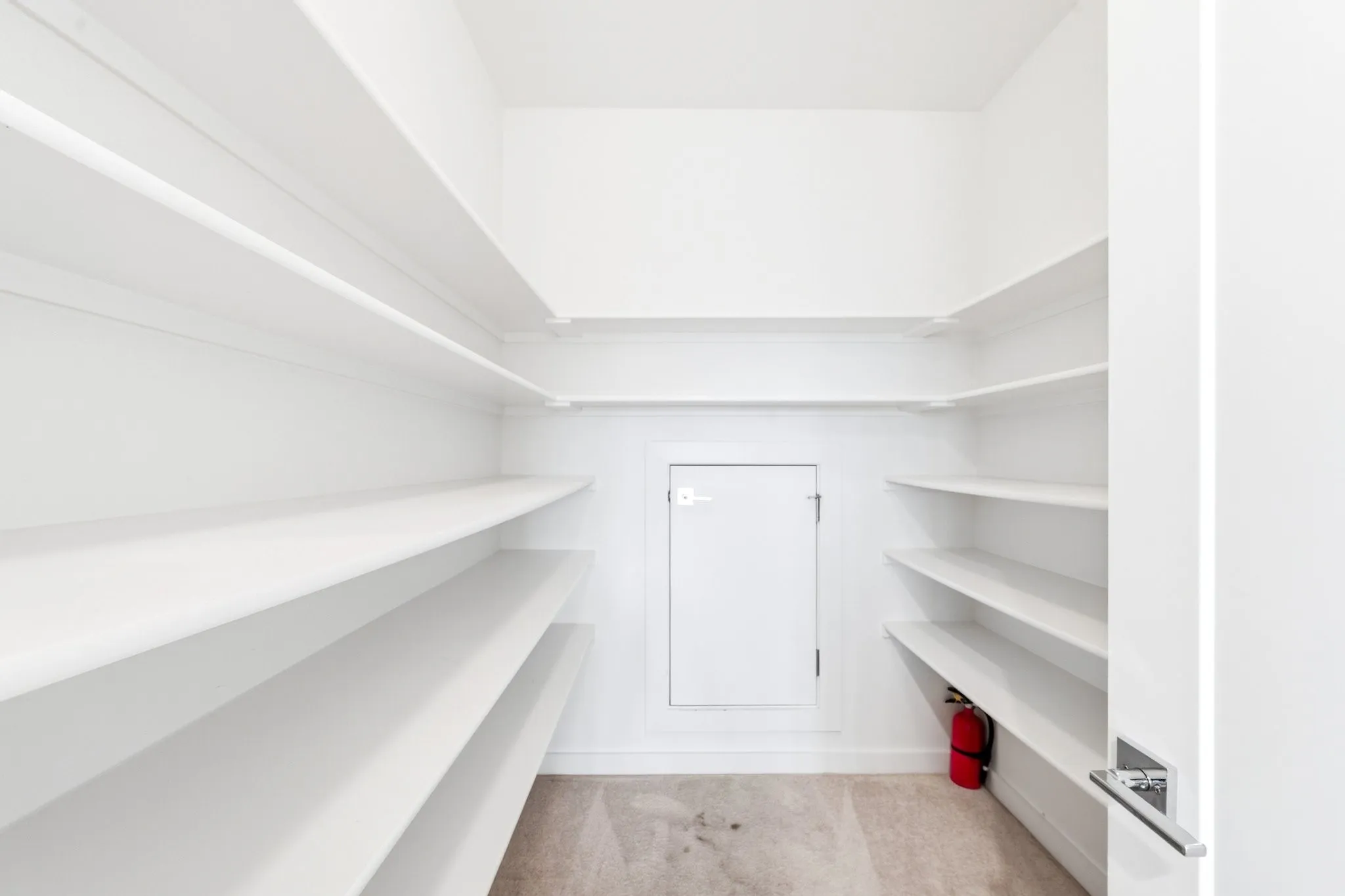 Deep built-in hallway storage featuring direct access to an expansive walk-in attic space.