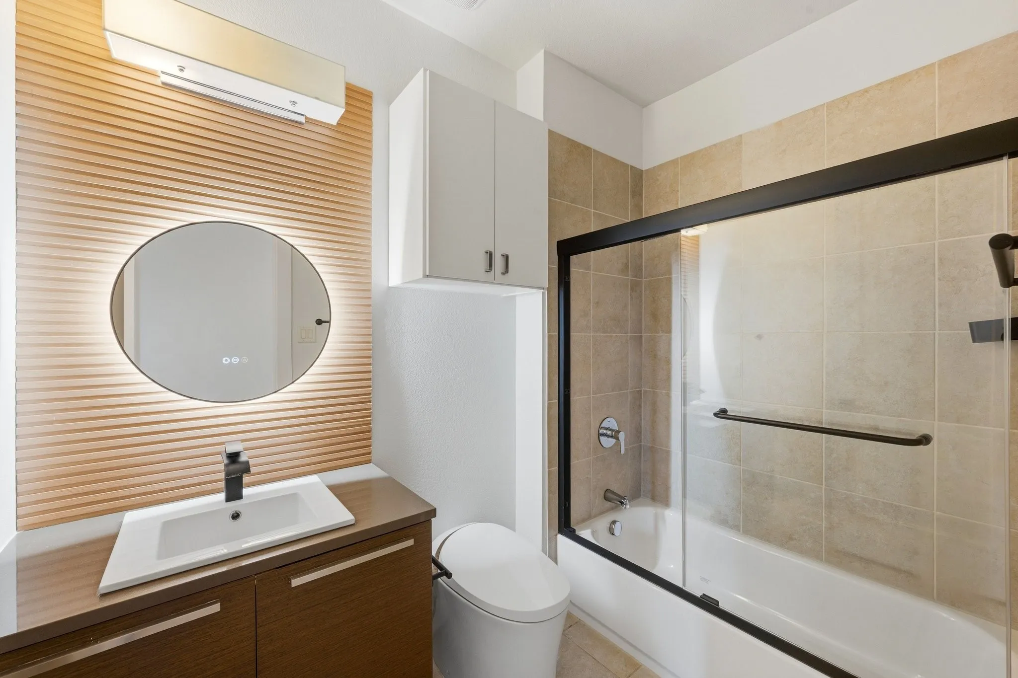 High-end remodeled bathroom showcasing modern finishes and luxury backlit mirror