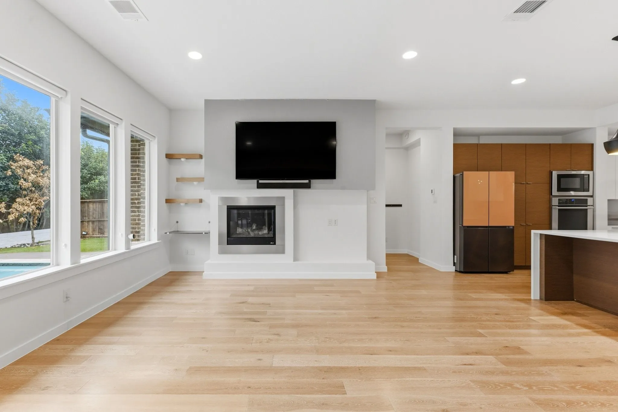 Soaring ceilings and rich hardwood floors create an inviting main living environment.