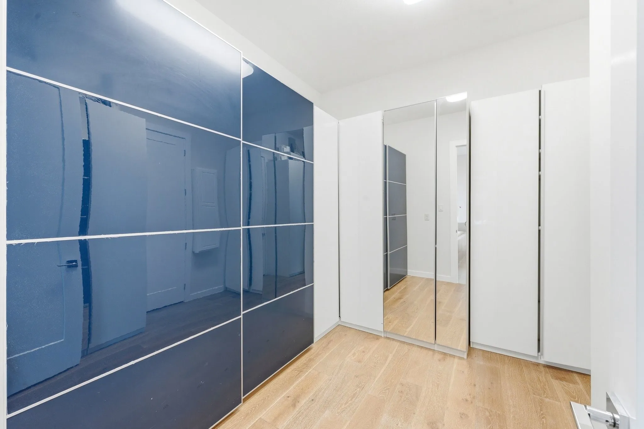 Custom primary walk-in closet complete with built-in shelving, drawers, and shoe storage.