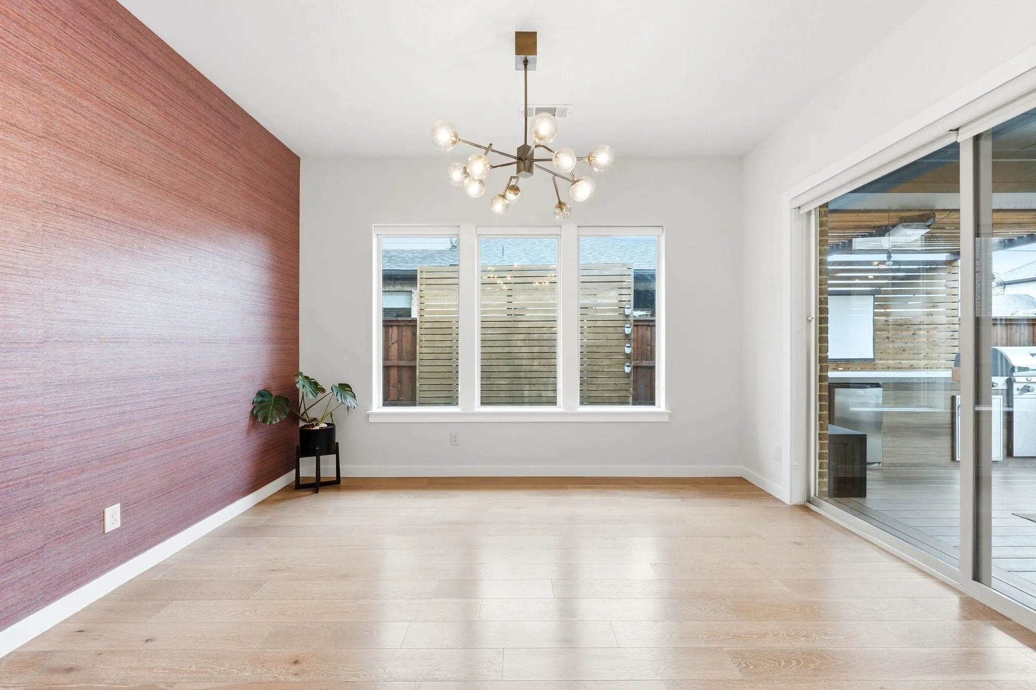 Elegant formal dining space wrapped in light with seamless access to outdoor living.