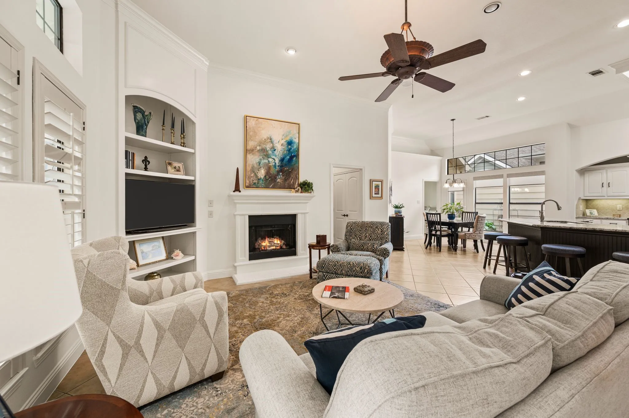 Living room with gas log fireplace and built-in shelving