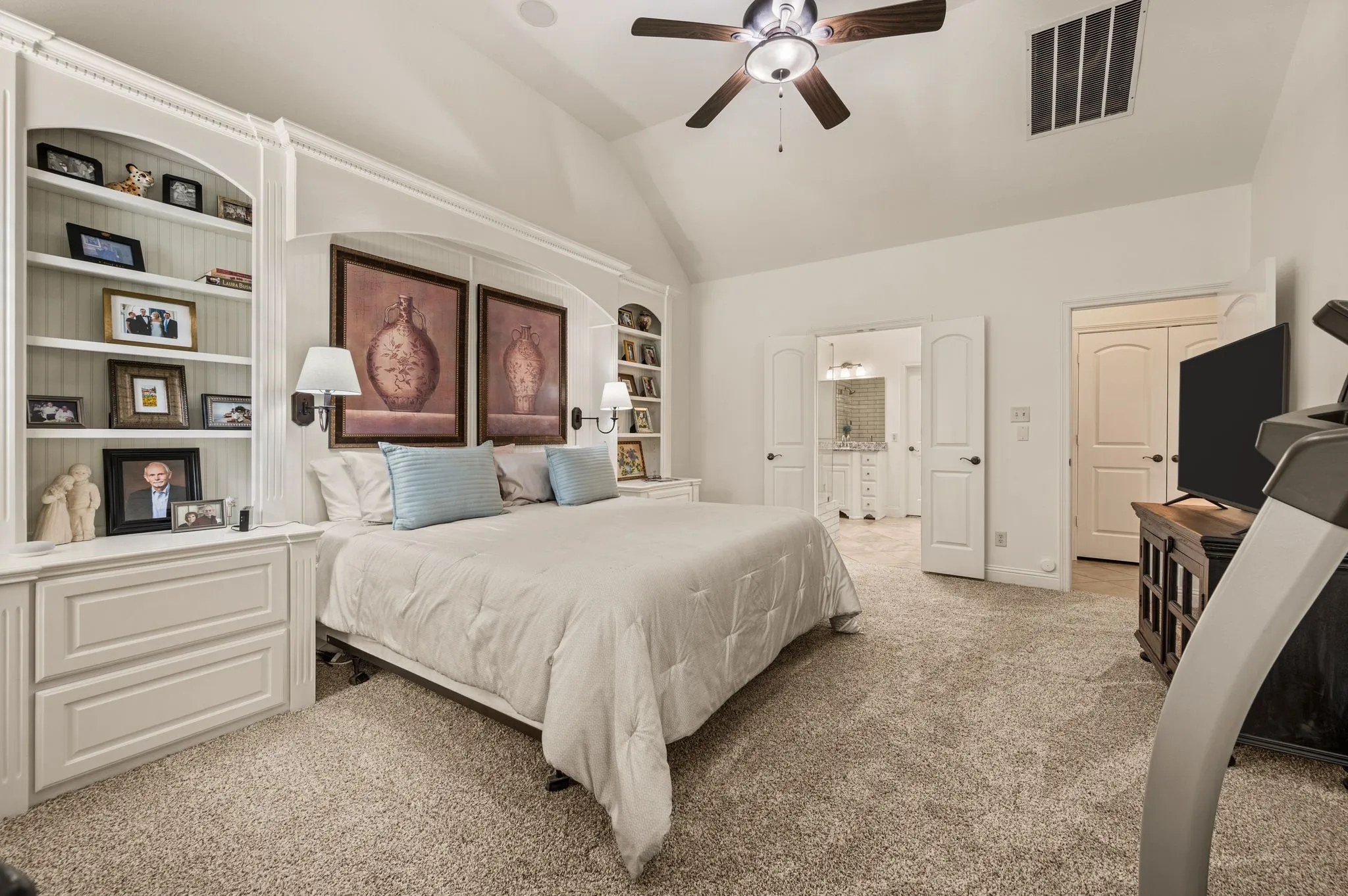 Primary bedroom has a built-in headboard and storage