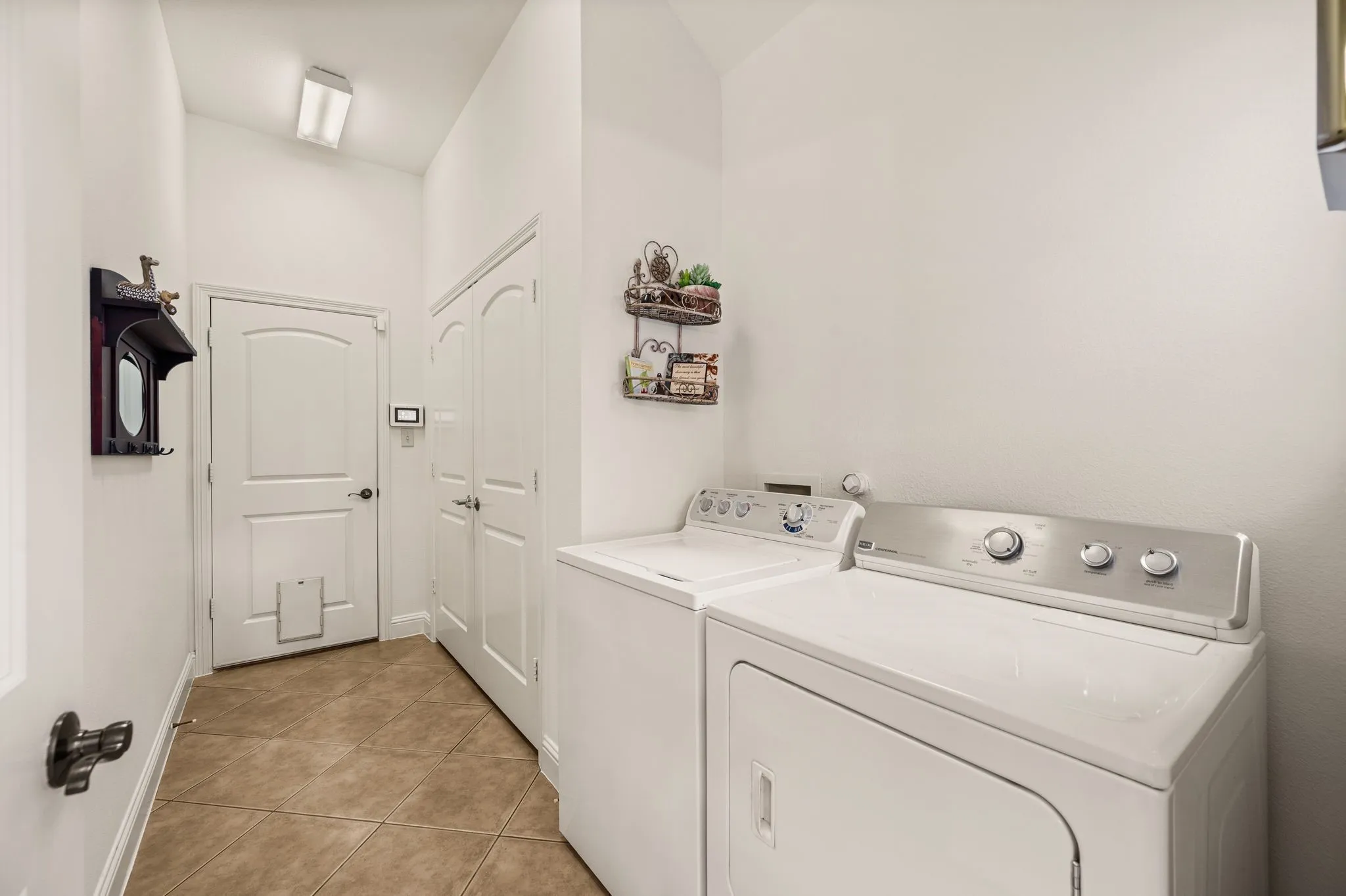 Utility room has a huge storage closet. Makes a great second pantry.