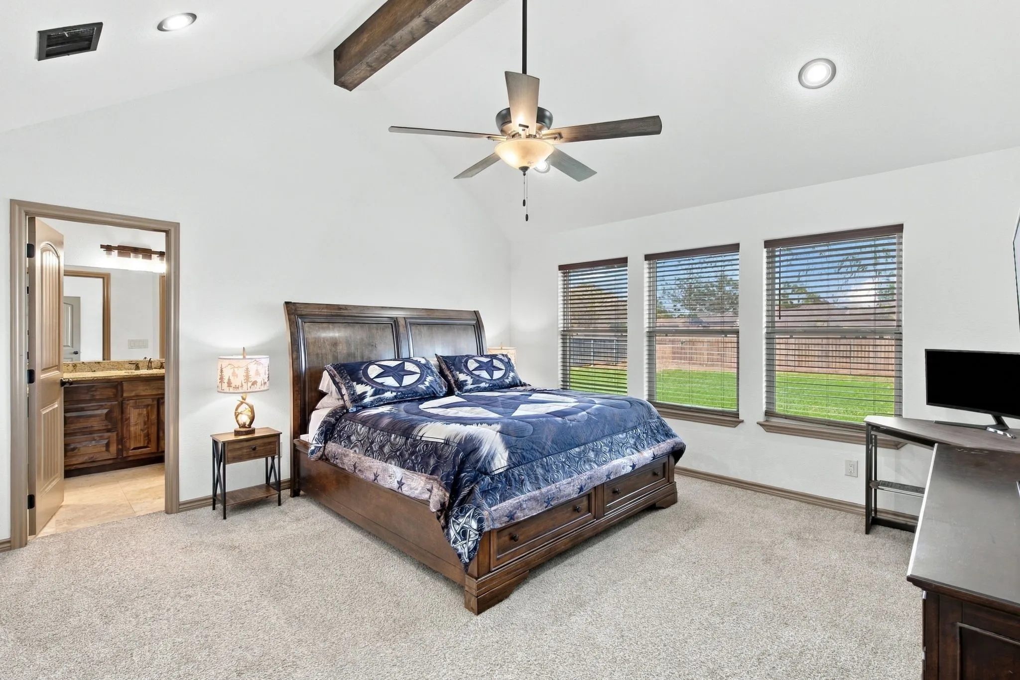 Vaulted ceiling with wood beam accent, recessed lighting, ceiling fan, and carpet flooring
