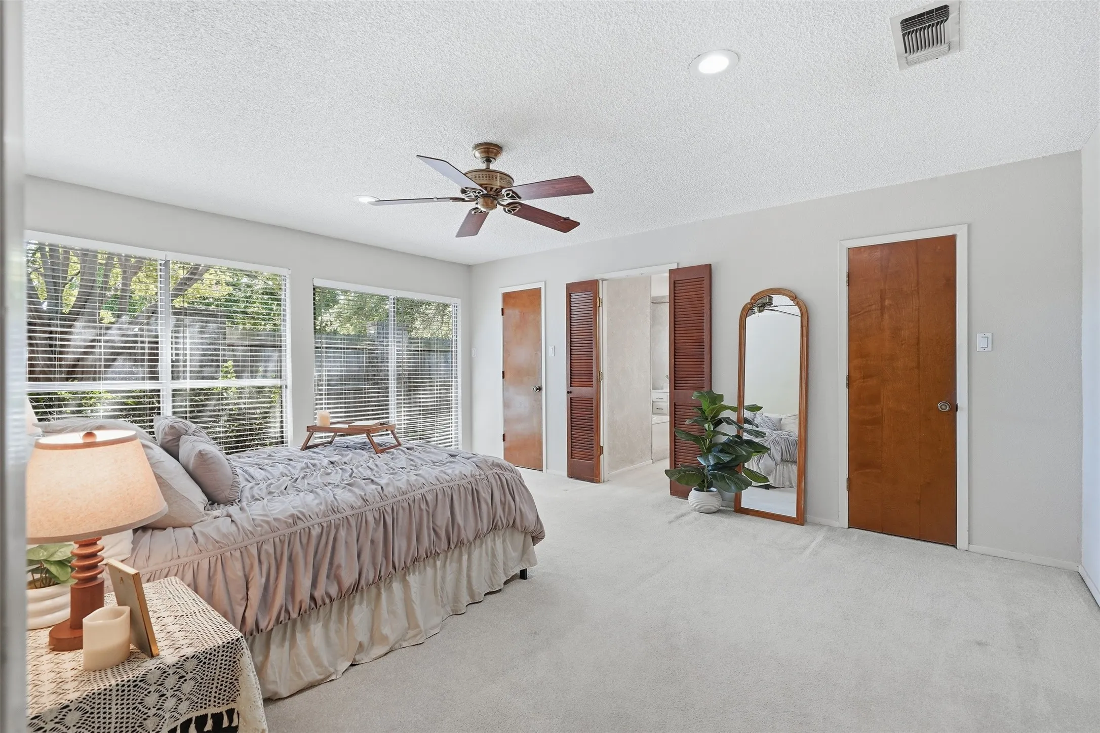 Recessed lighting, wood-finish doors, and a ceiling fan with light fixture