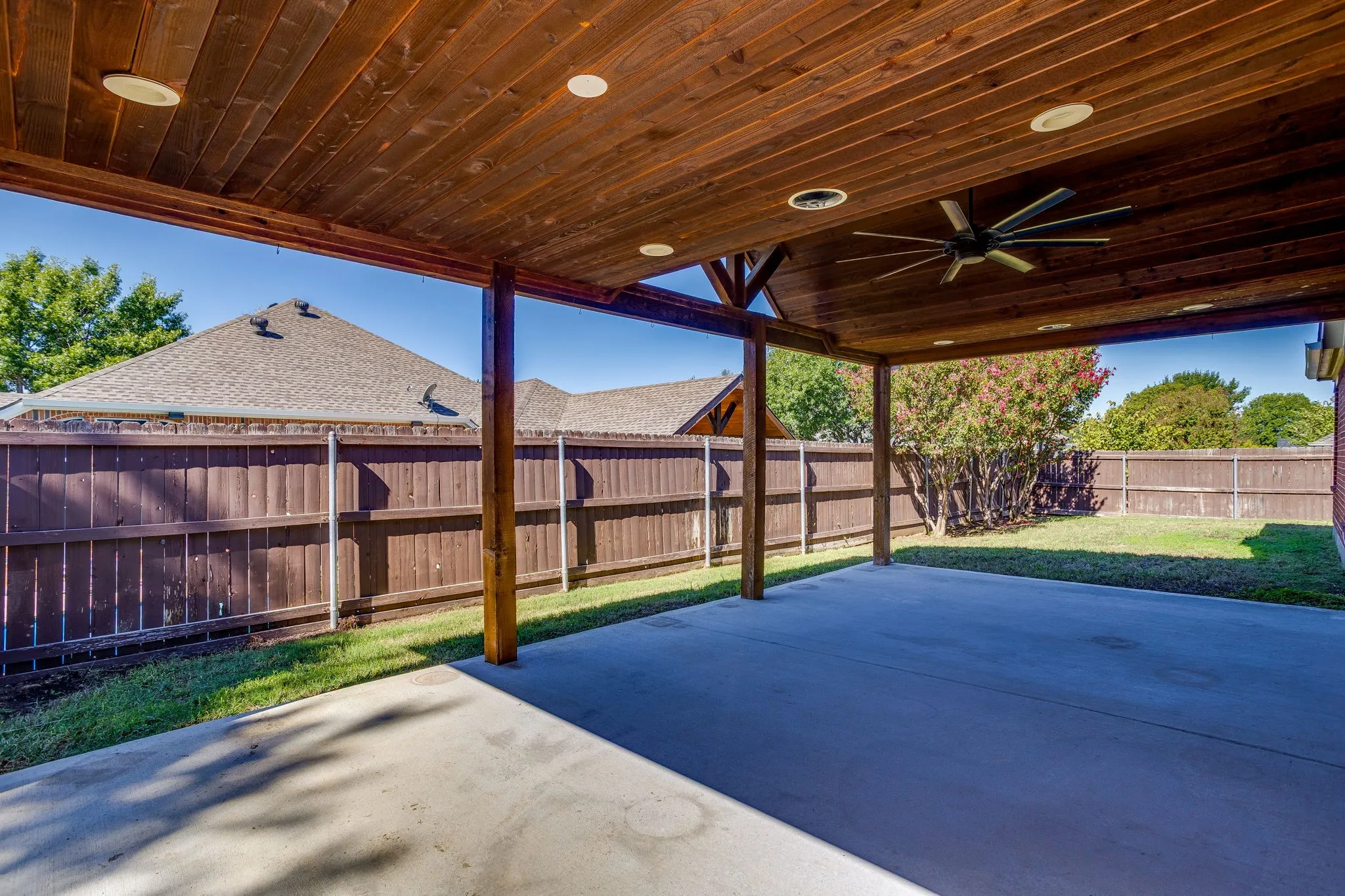 Covered patio with a wood-plank ceiling, recessed lighting, and a ceiling fan