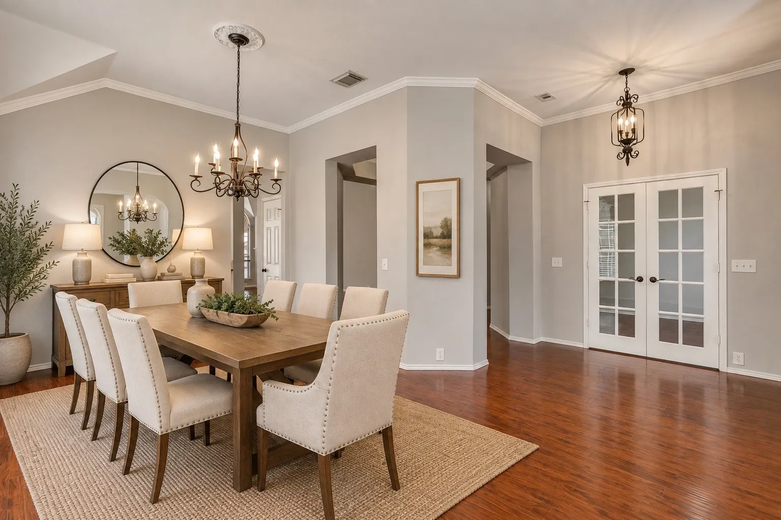 Hardwood-style flooring with a high-gloss finish, recessed lighting, and crown molding. This photo was virtually staged using AI