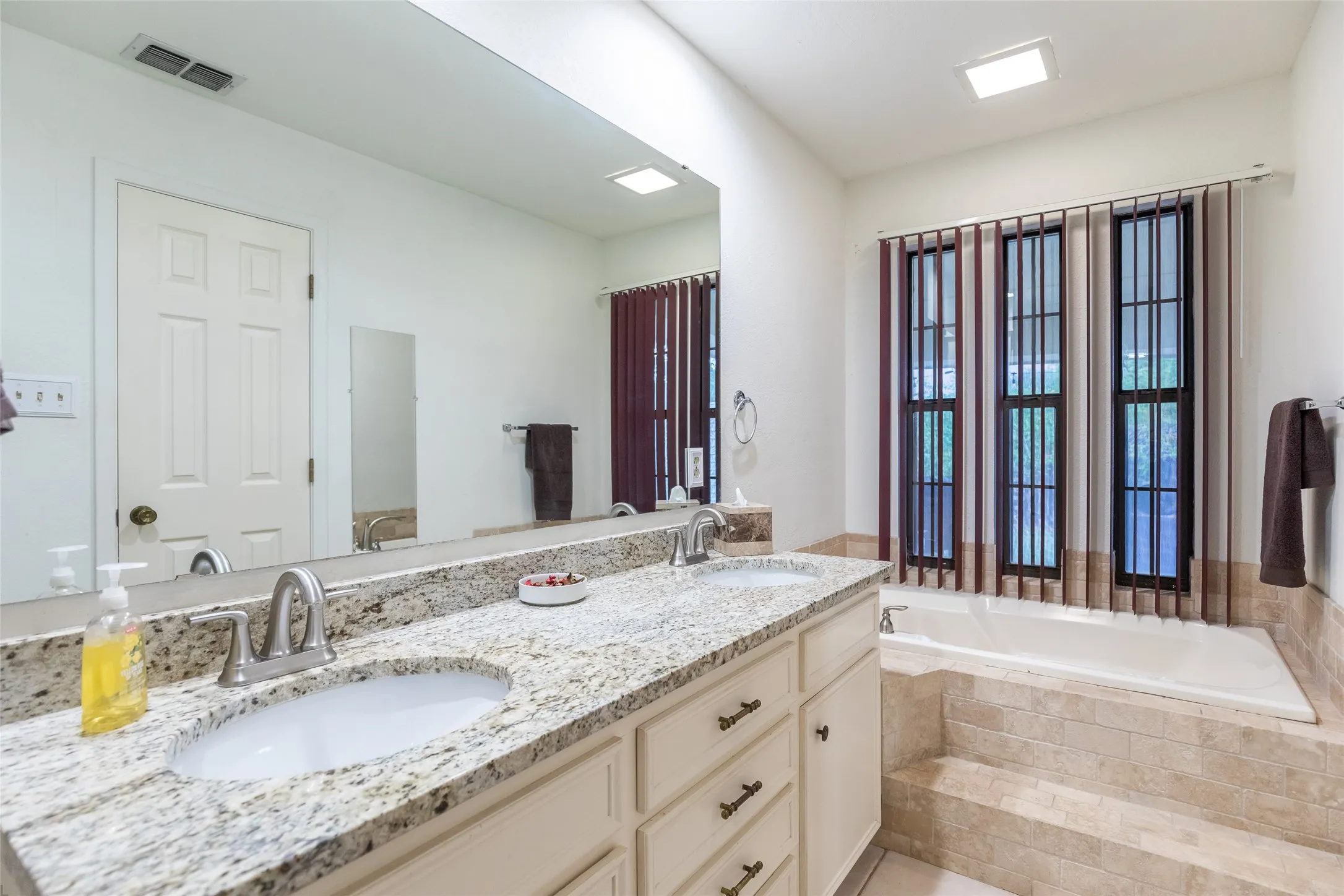 Dual vanity with granite-style countertops and undermount sinks