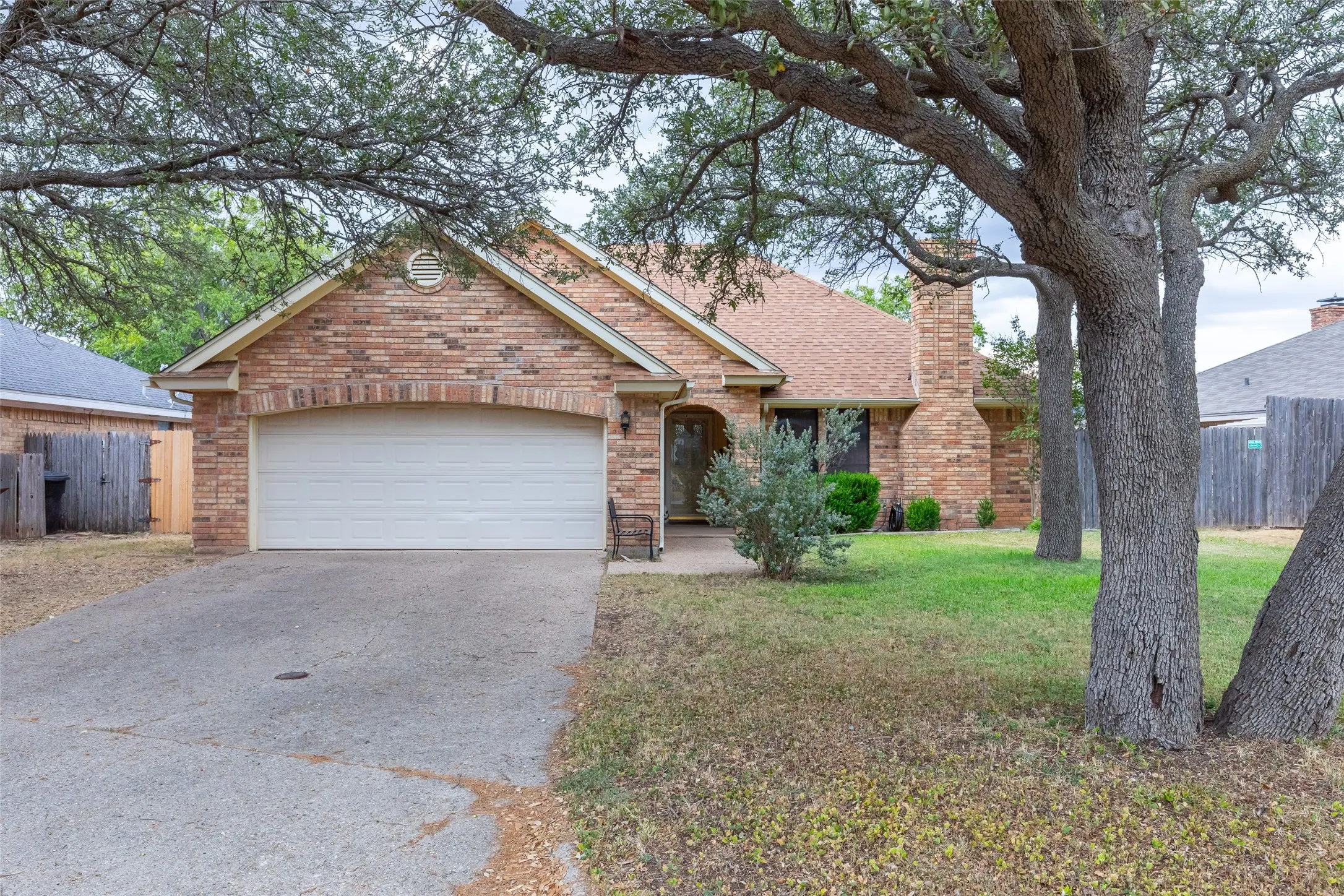 Brick exterior with an attached garage and arched entry