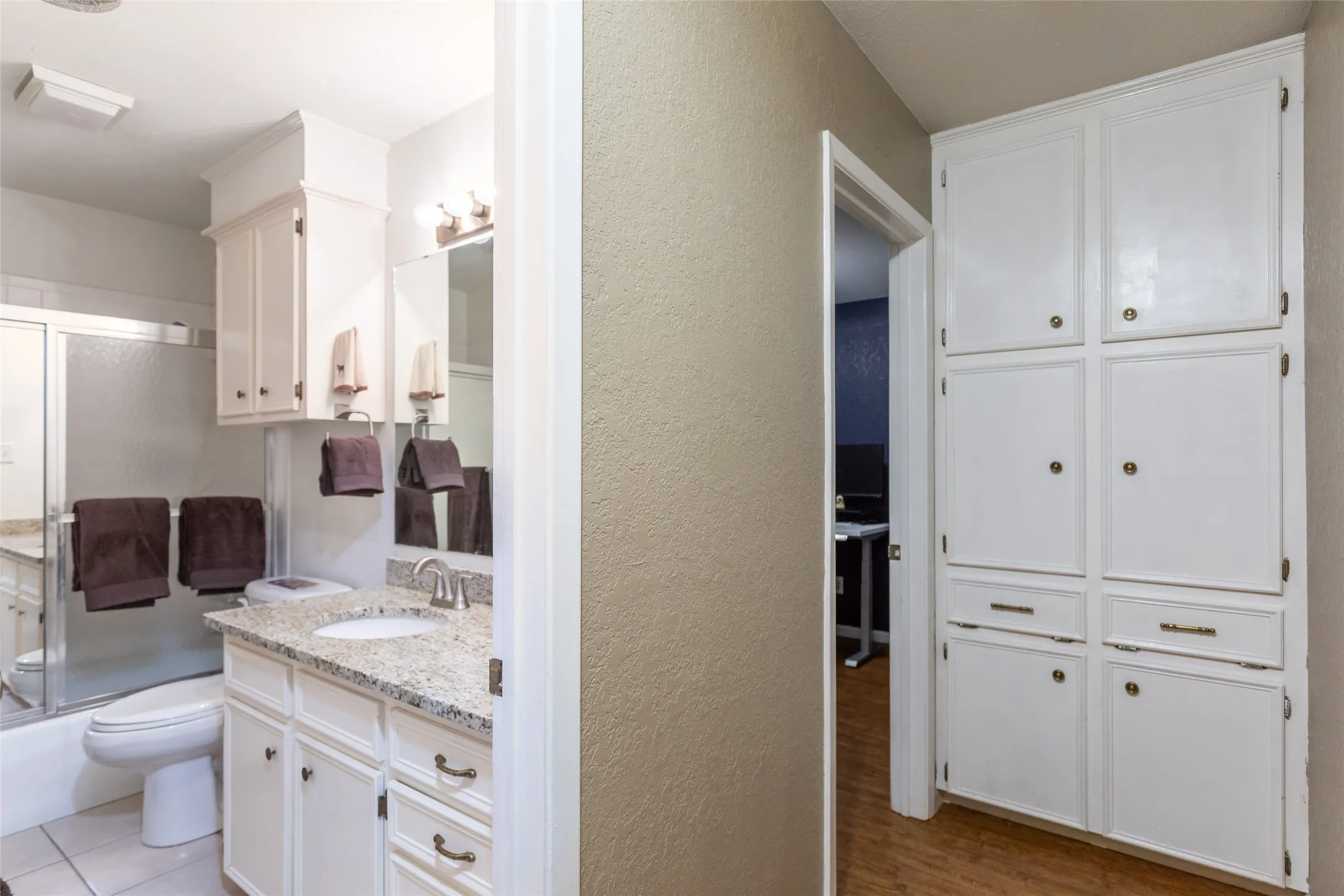 Bathroom featuring a vanity with a white basin and a light-colored countertop