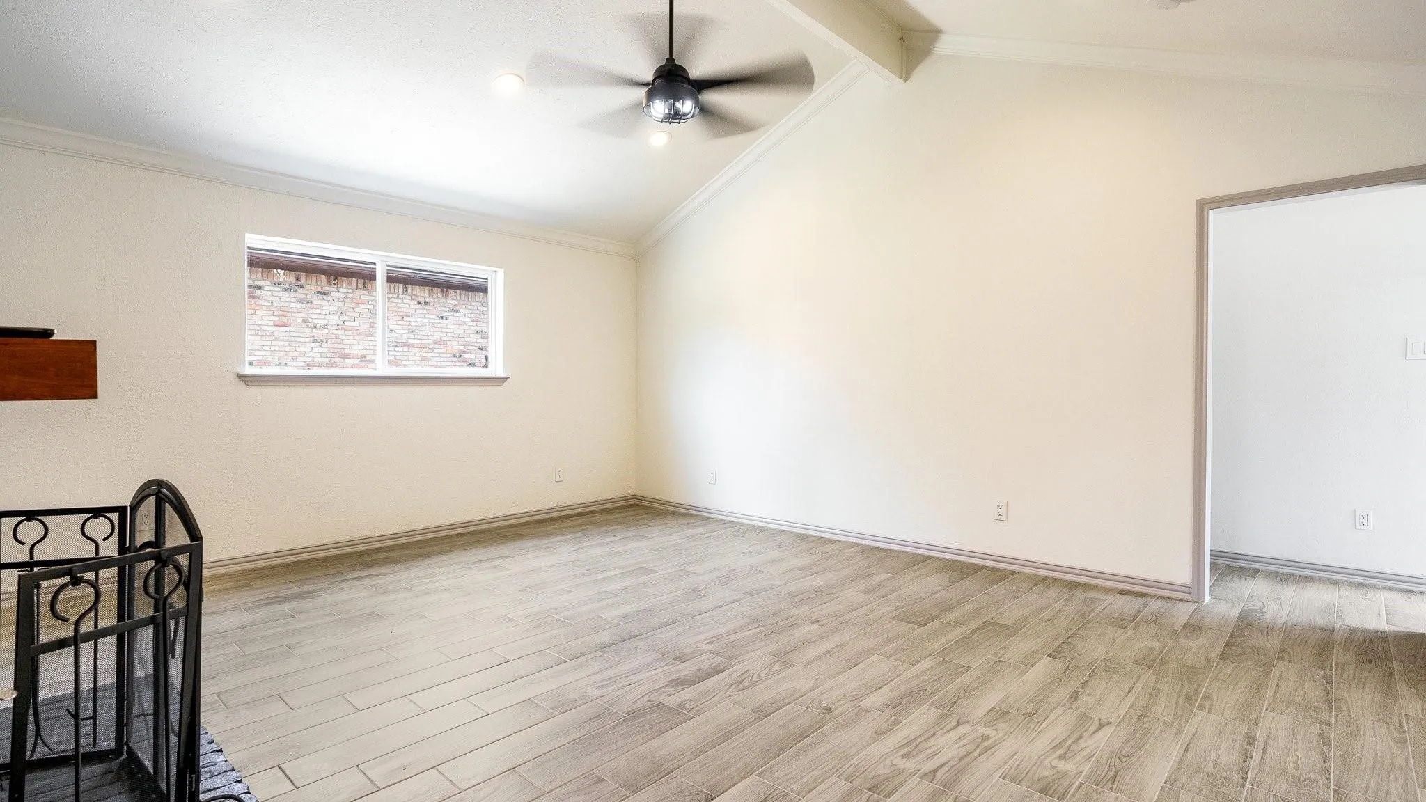 Vaulted ceiling, wood-finish flooring, recessed lighting, and ceiling fan with integrated lighting