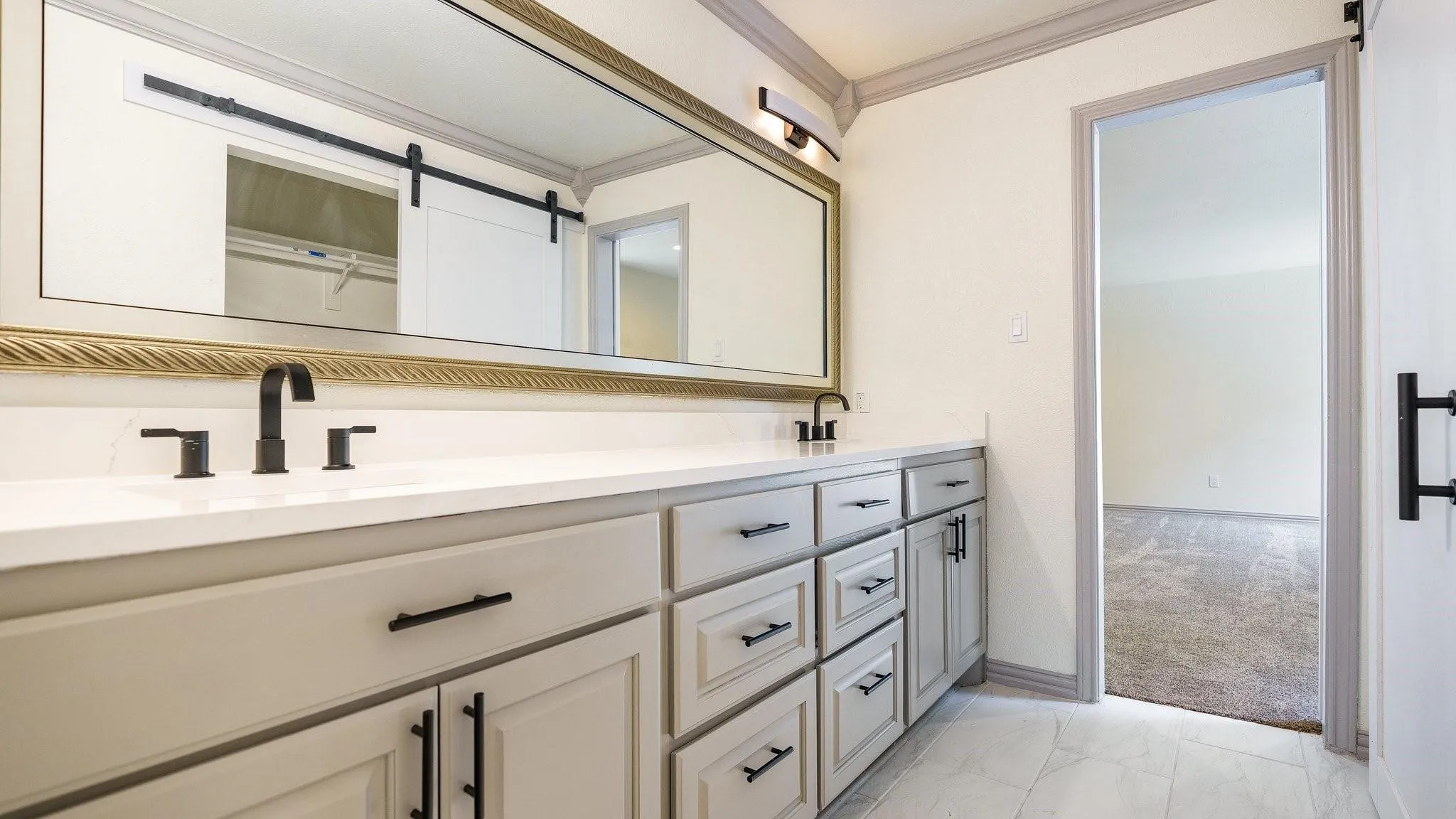 Dual vanity with a white countertop, undermount sinks, and matte black fixtures
