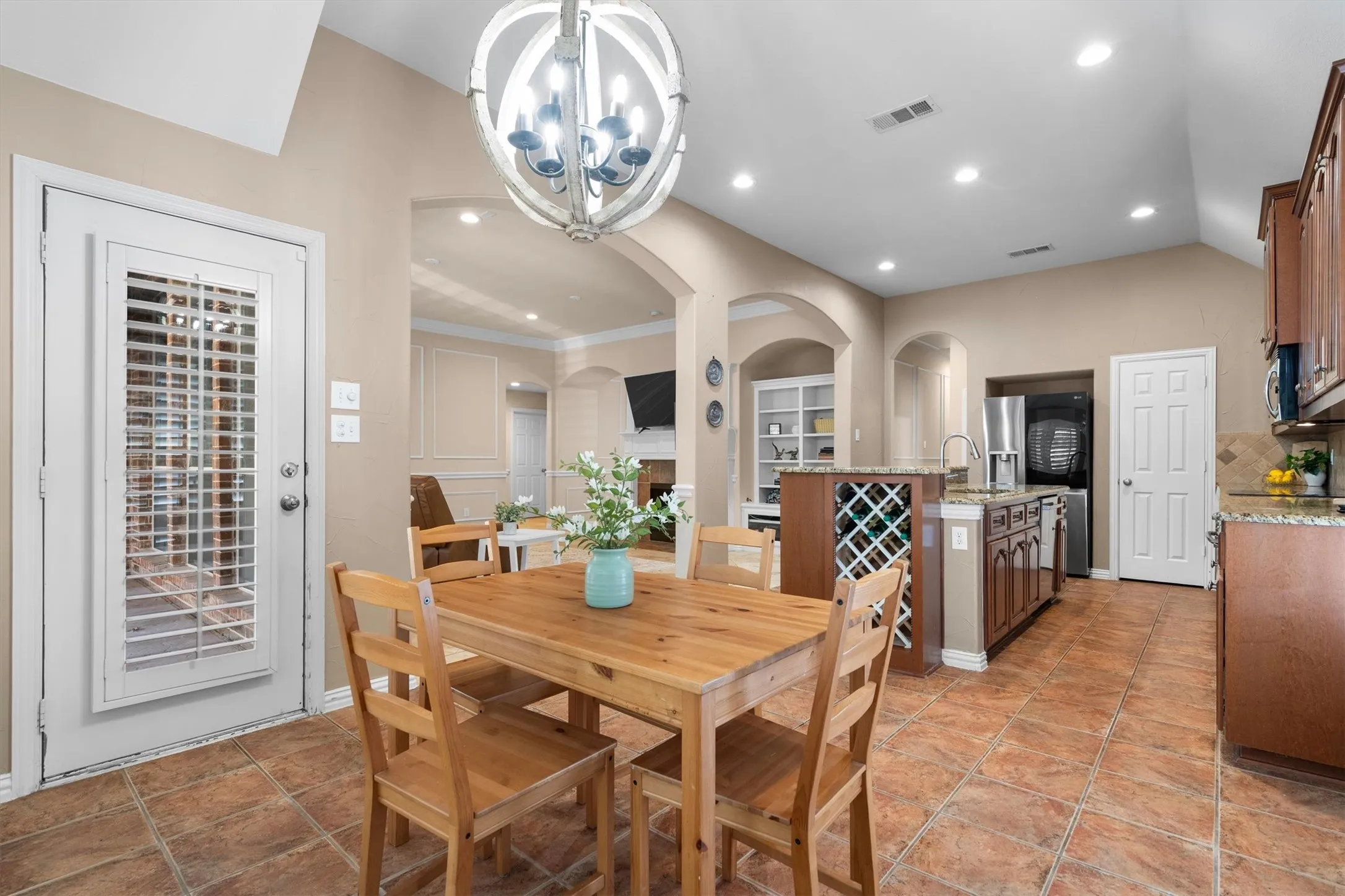 Kitchen featuring tile flooring, recessed lighting, and a kitchen island with built-in wine storage