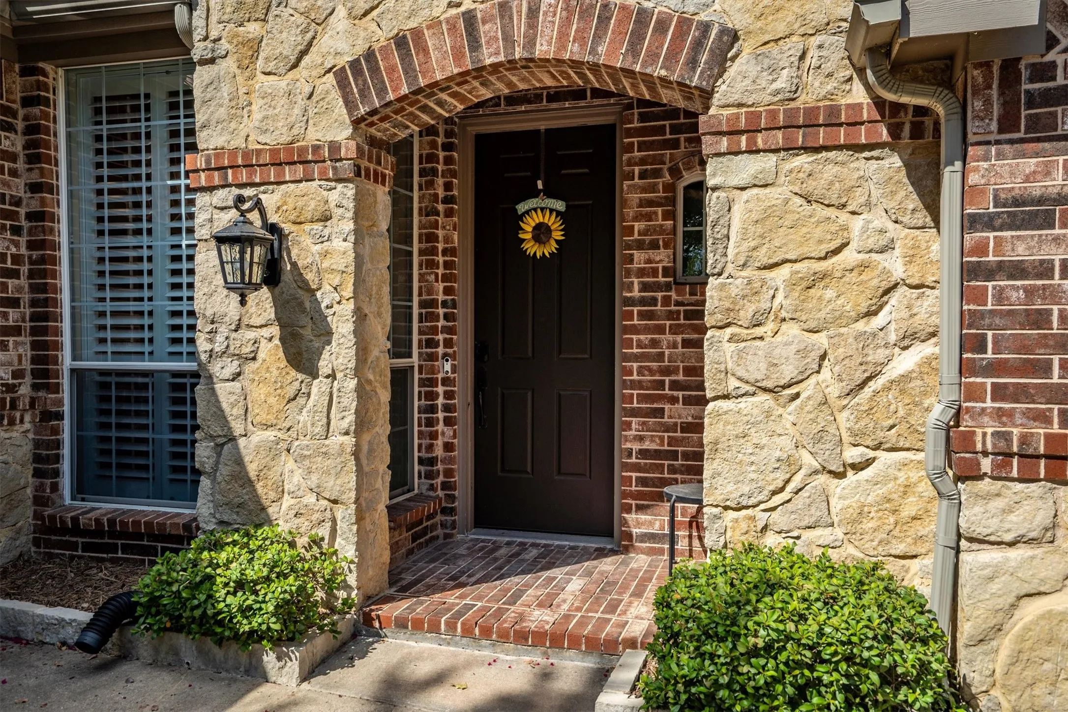 Brick and stone exterior with an arched entryway