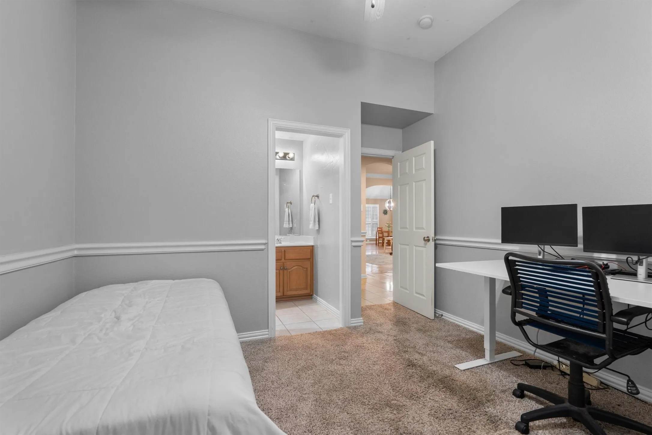 Carpeted room featuring chair rail molding
