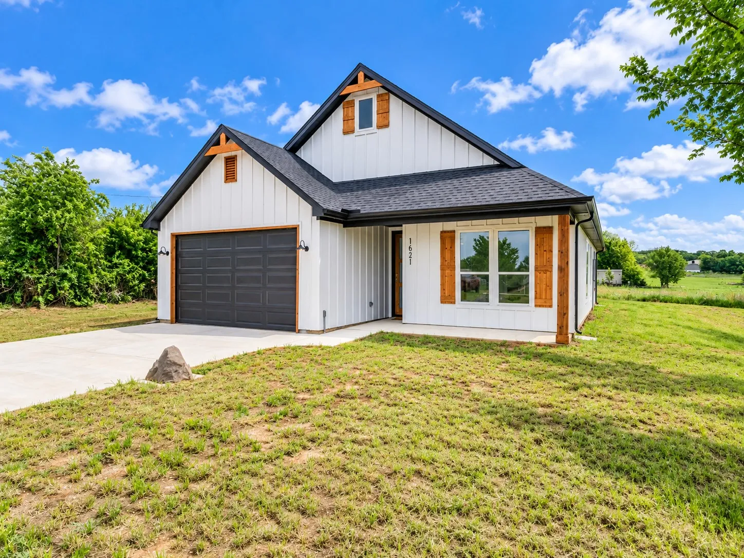 White vertical siding exterior with dark roof and wood-tone accents