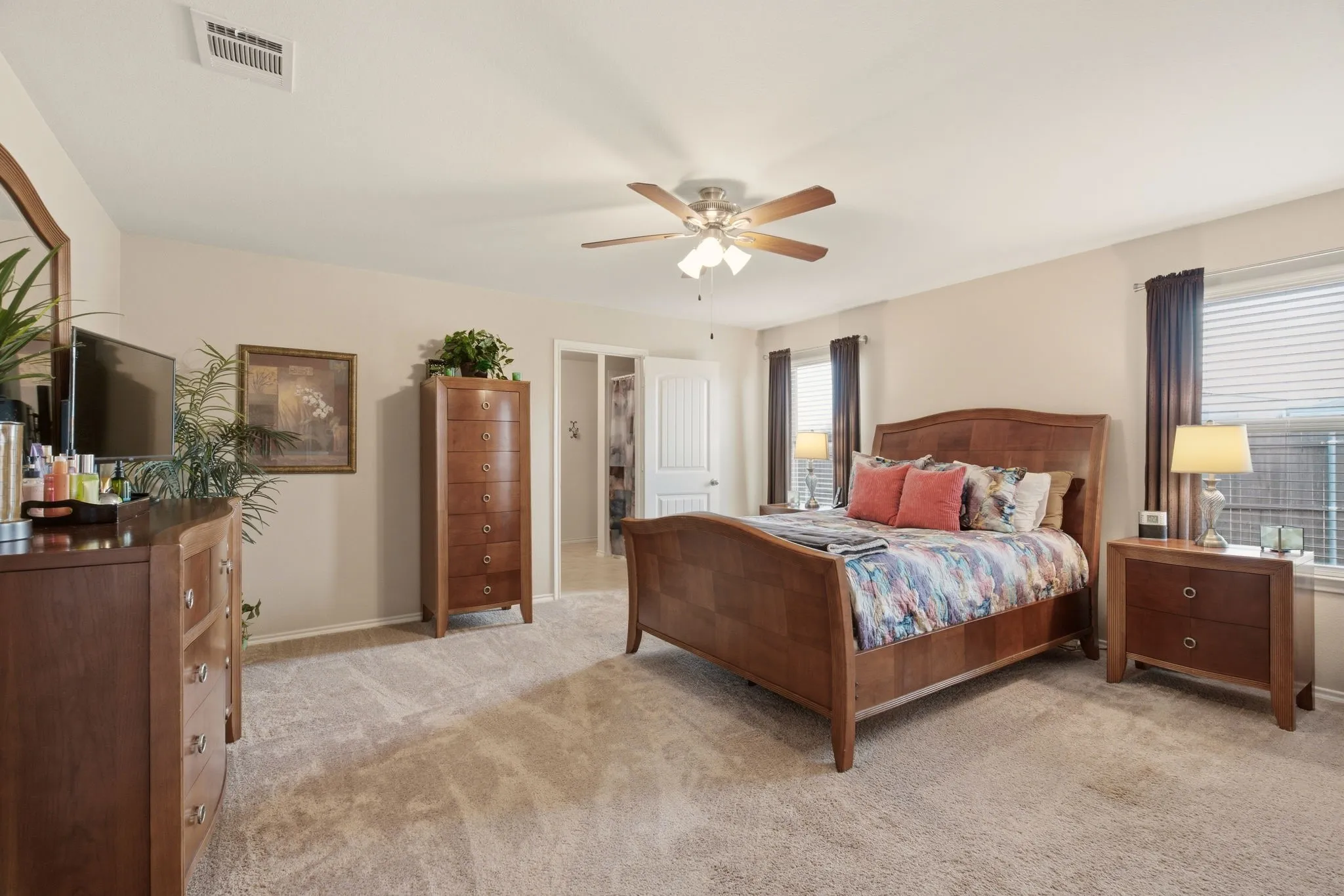 Secluded primary suite offers a serene retreat, large enough for a sitting area & any size bedroom suit.
