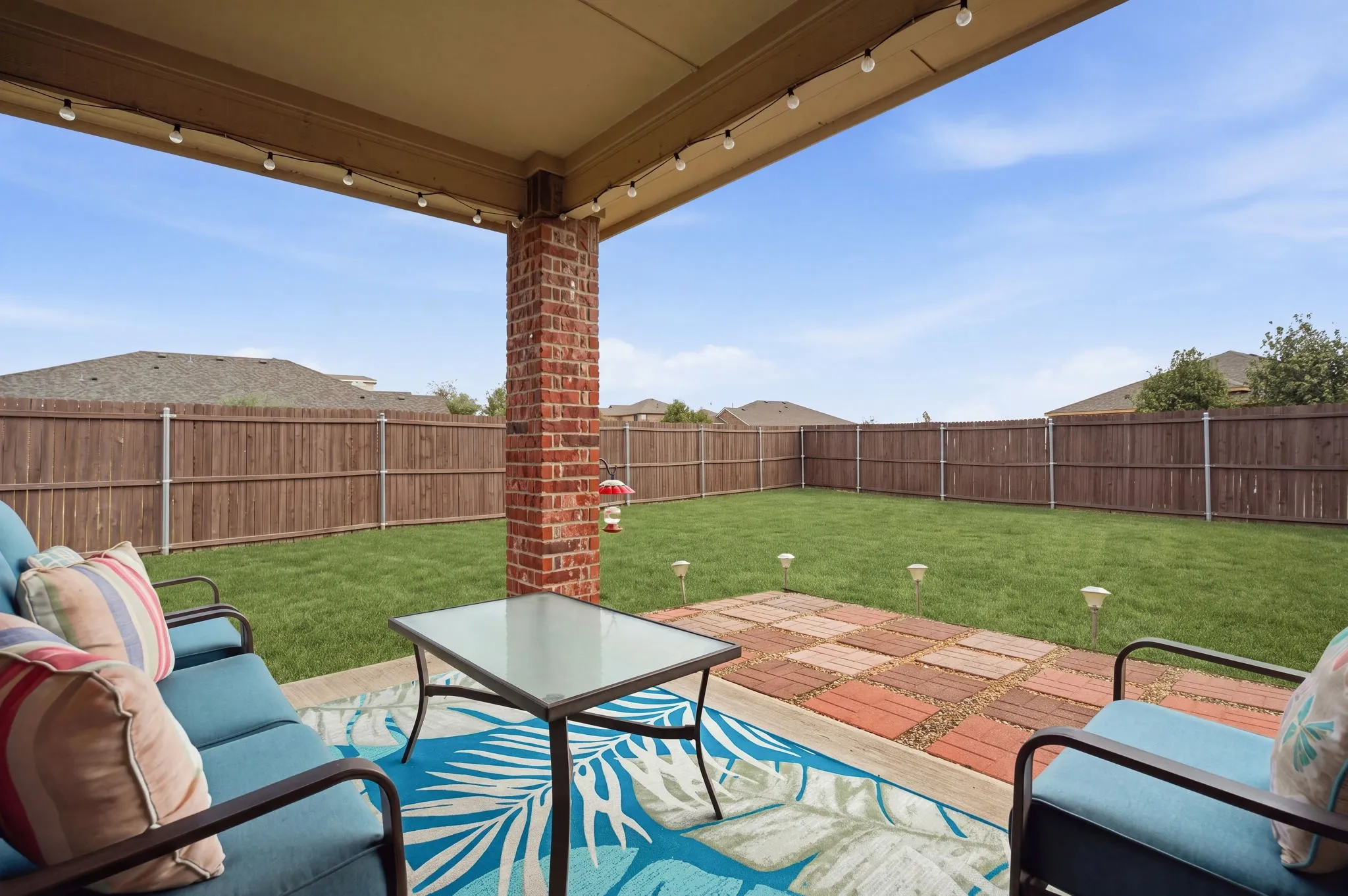 Tranquil all year long on the covered patio. NE exposure means shade in the afternoon. For added ambiance, the seller is leaving the solar landscape lighting & string lights!