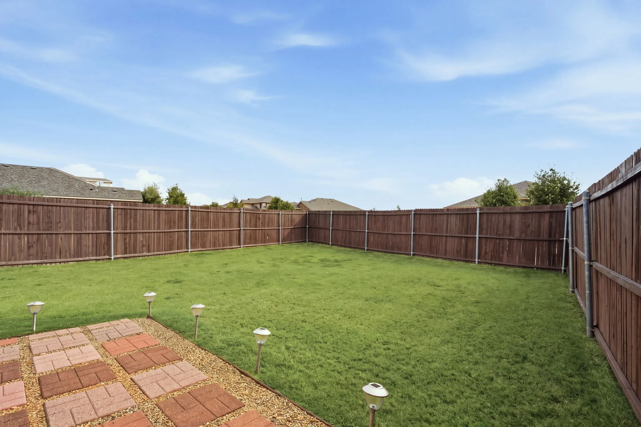 Privacy with no adjacent neighbors. Behind the fence on the left side is one of the community walking paths, offering more distance between you & neighboring homes.