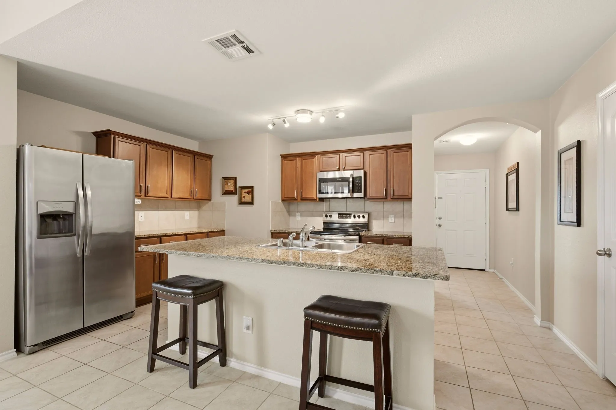 Bring your barstools for the island breakfast bar. Ample granite counter space for meal prep too.