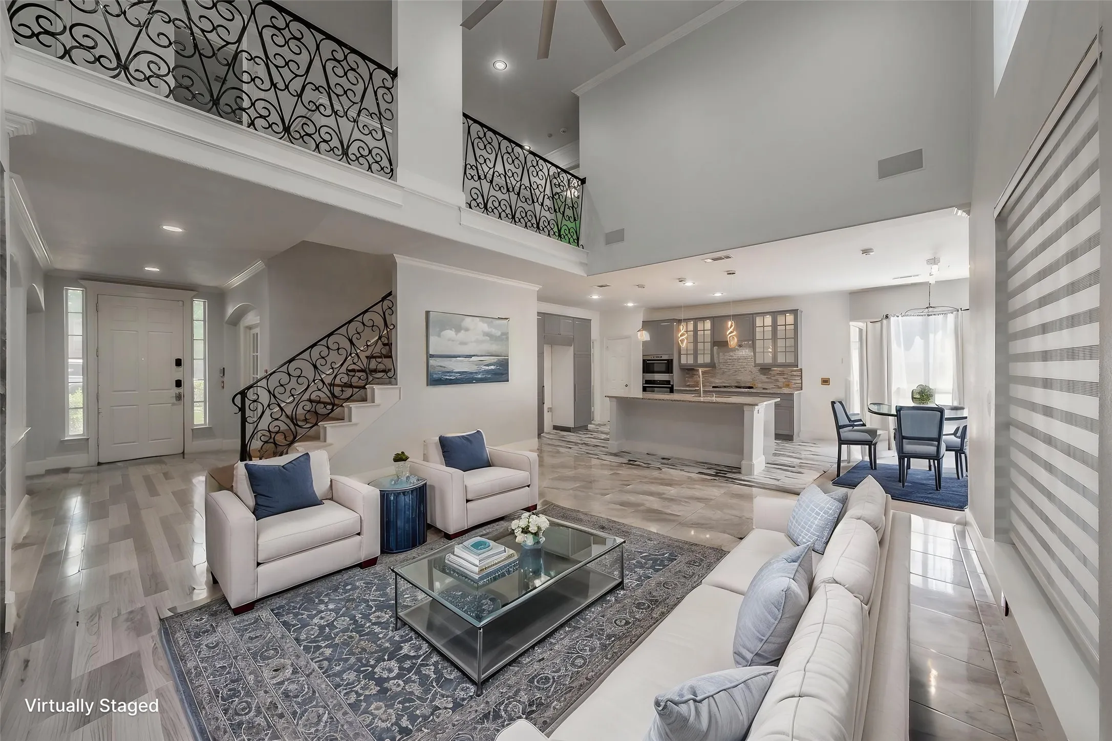 Virtually staged living room open to kitchen & breakfast area.