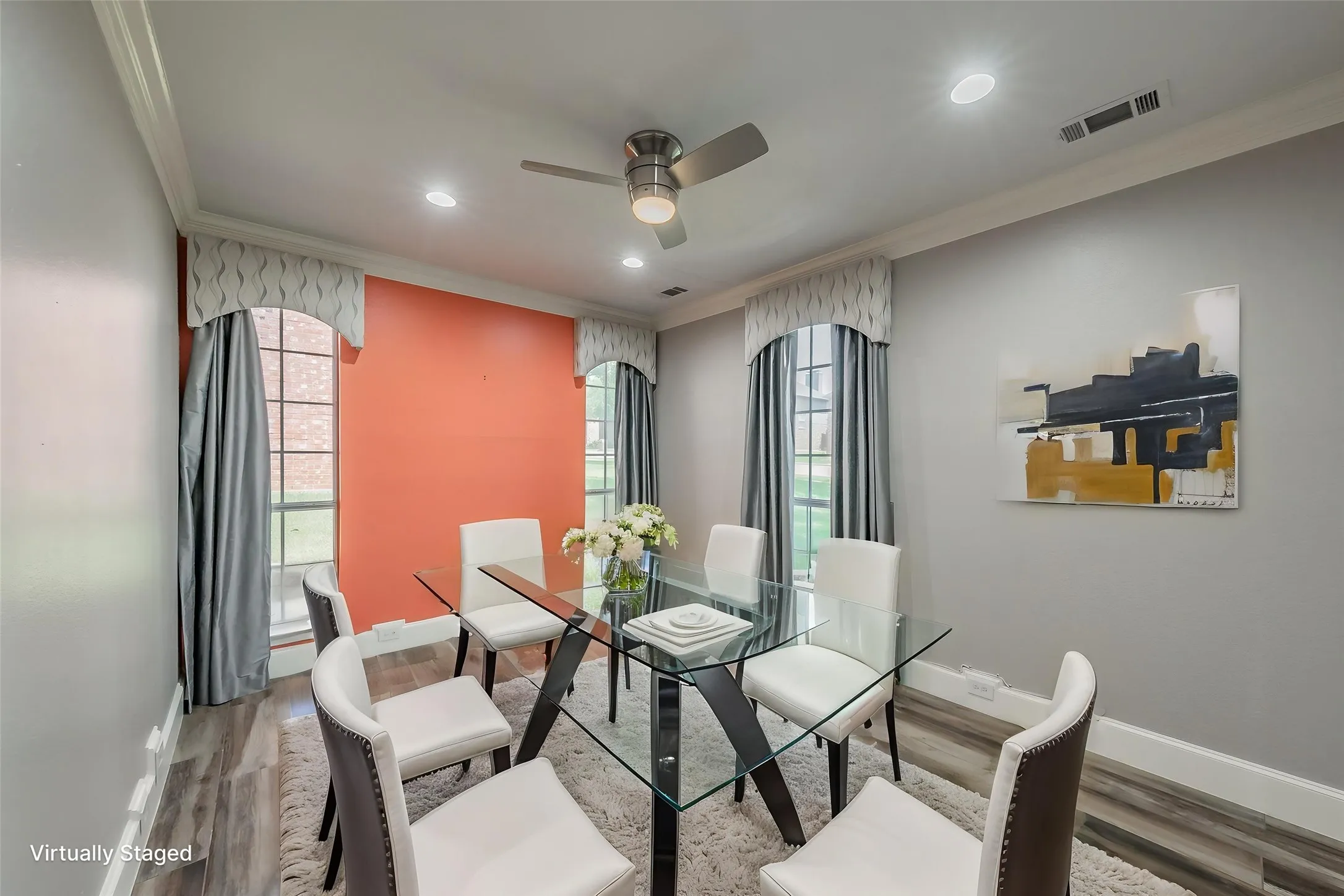 Formal dining room featuring crown molding, 5 inch base molding, and ceiling fan for added comfort.