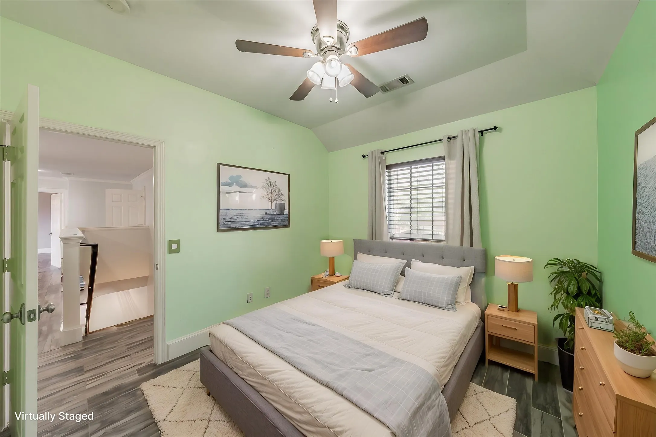 Tray ceiling with a ceiling fan, wood-finish flooring, and window with blinds