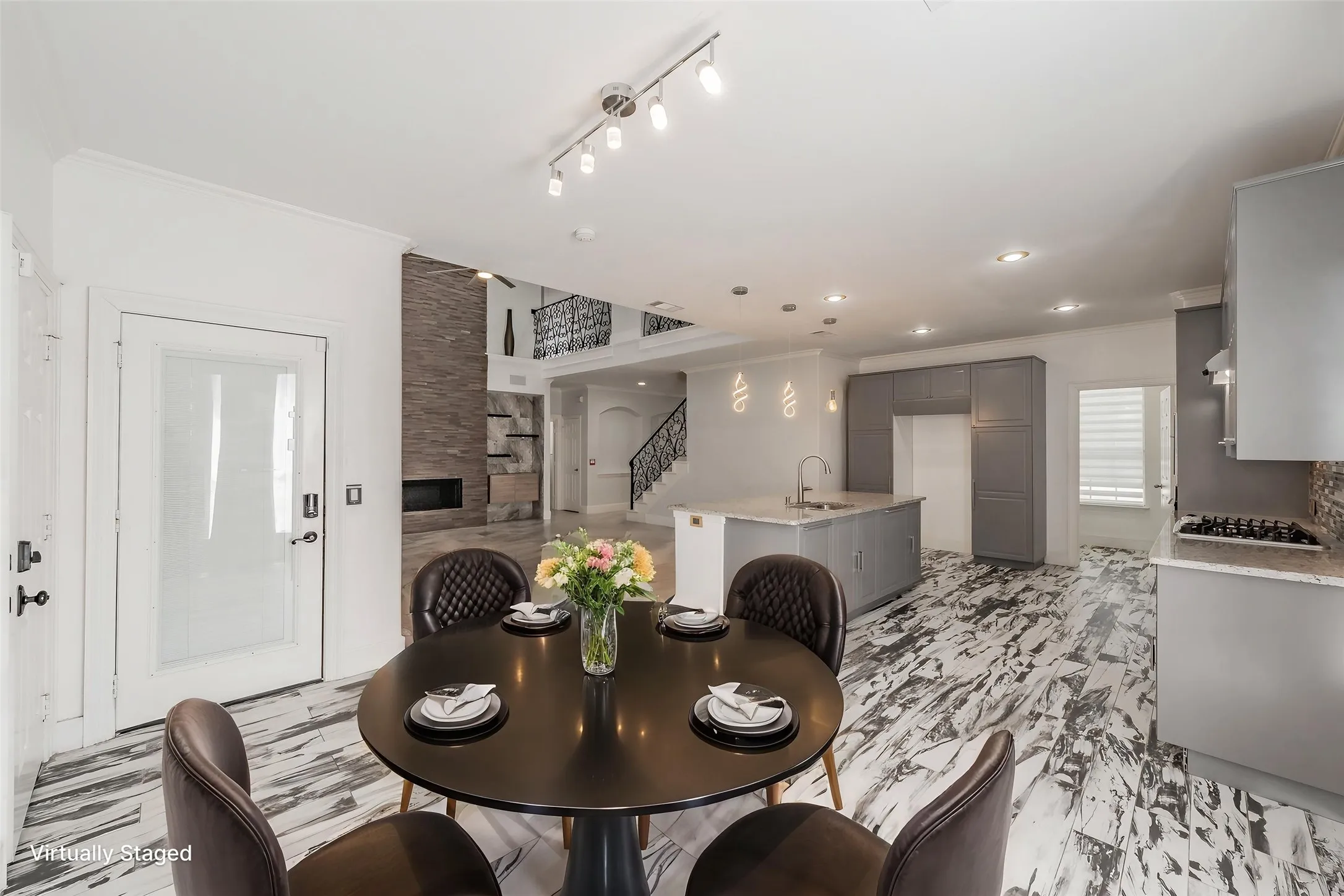 Virtually staged breakfast area is open to kitchen and living room.