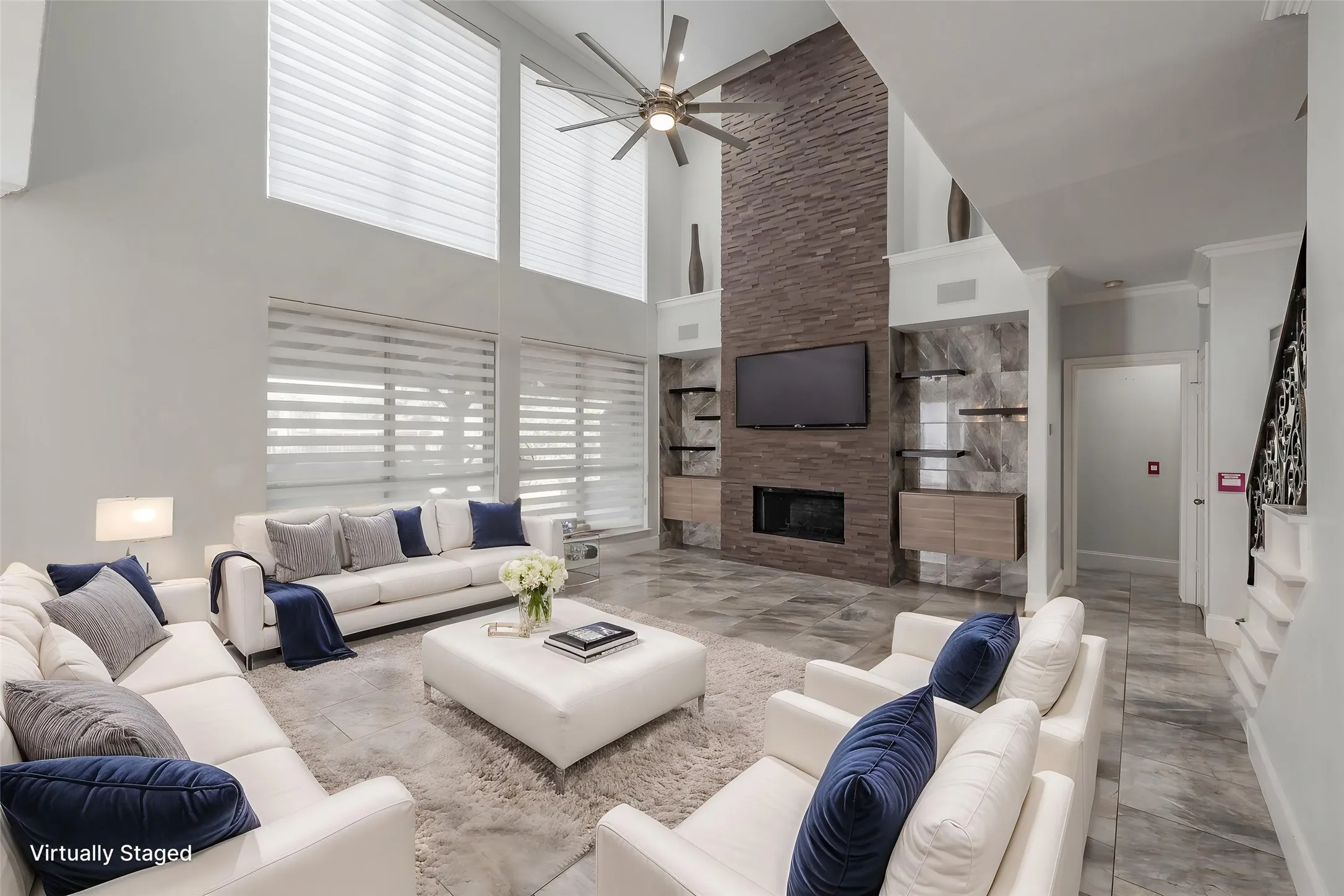Virtually staged livin room with impressive fireplace.