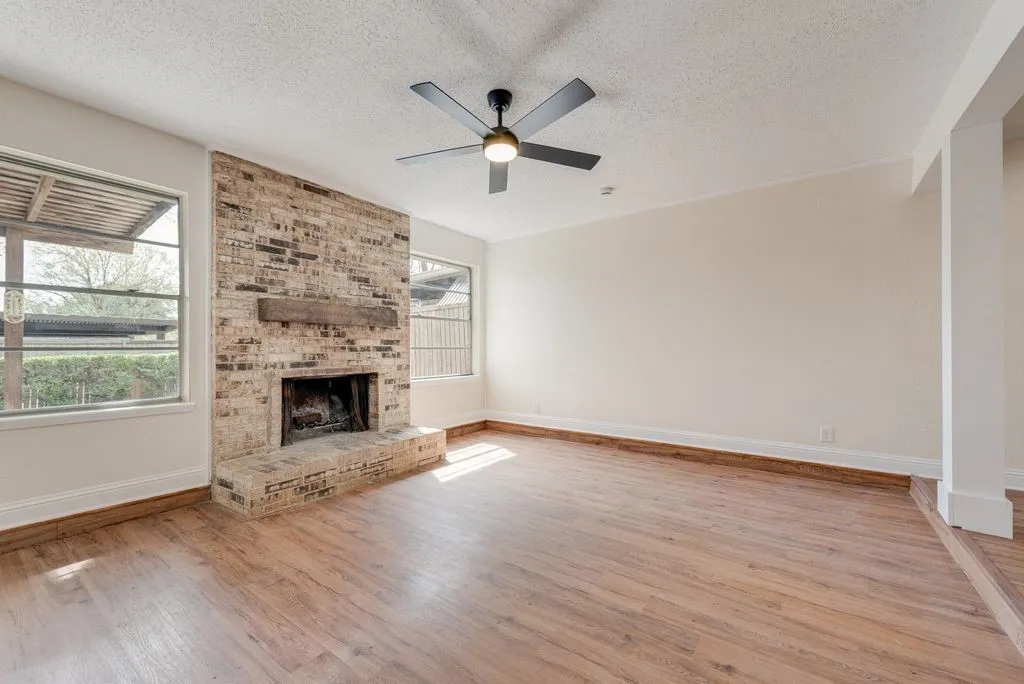 Brick fireplace with a wood mantel