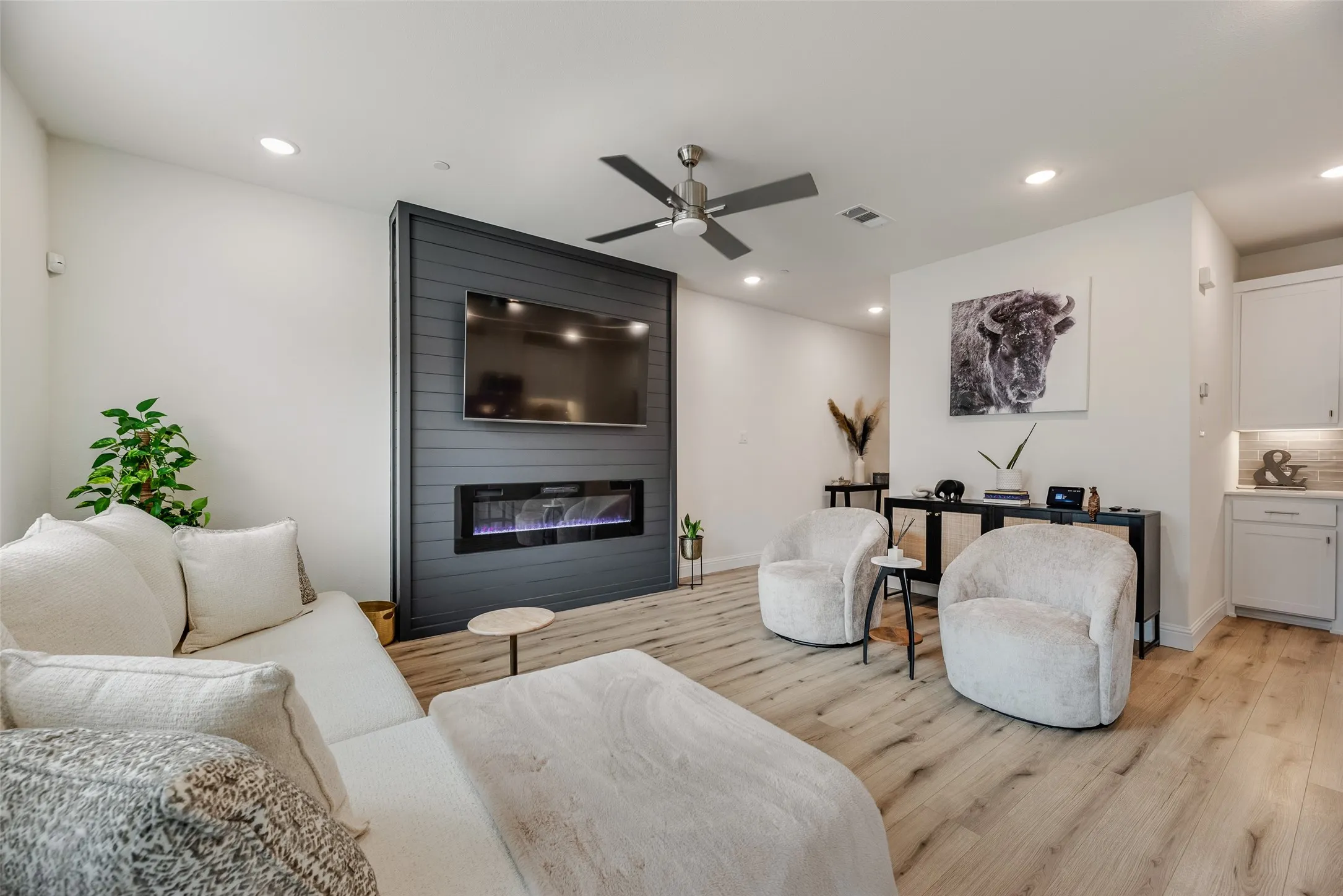 Wood-finish flooring, gorgeous feature fireplace, recessed lighting