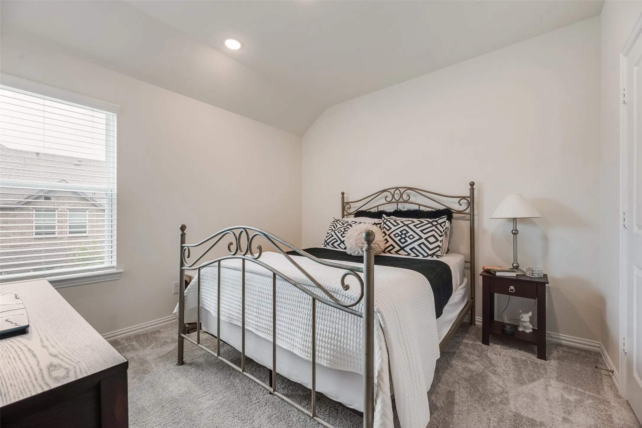Recessed lighting, window with blinds, light-toned walls, and carpet flooring