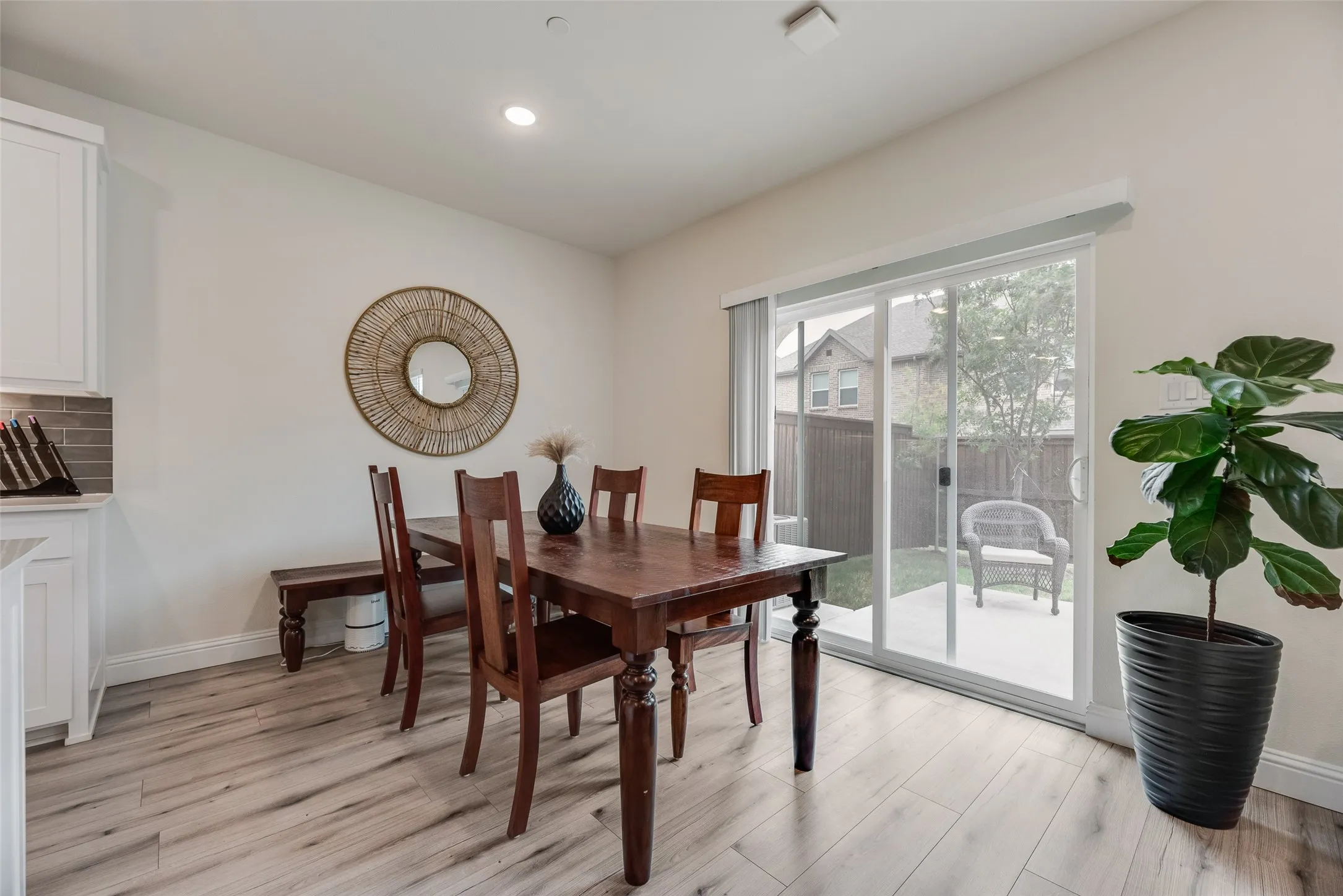 Dining room with wood-finish flooring.