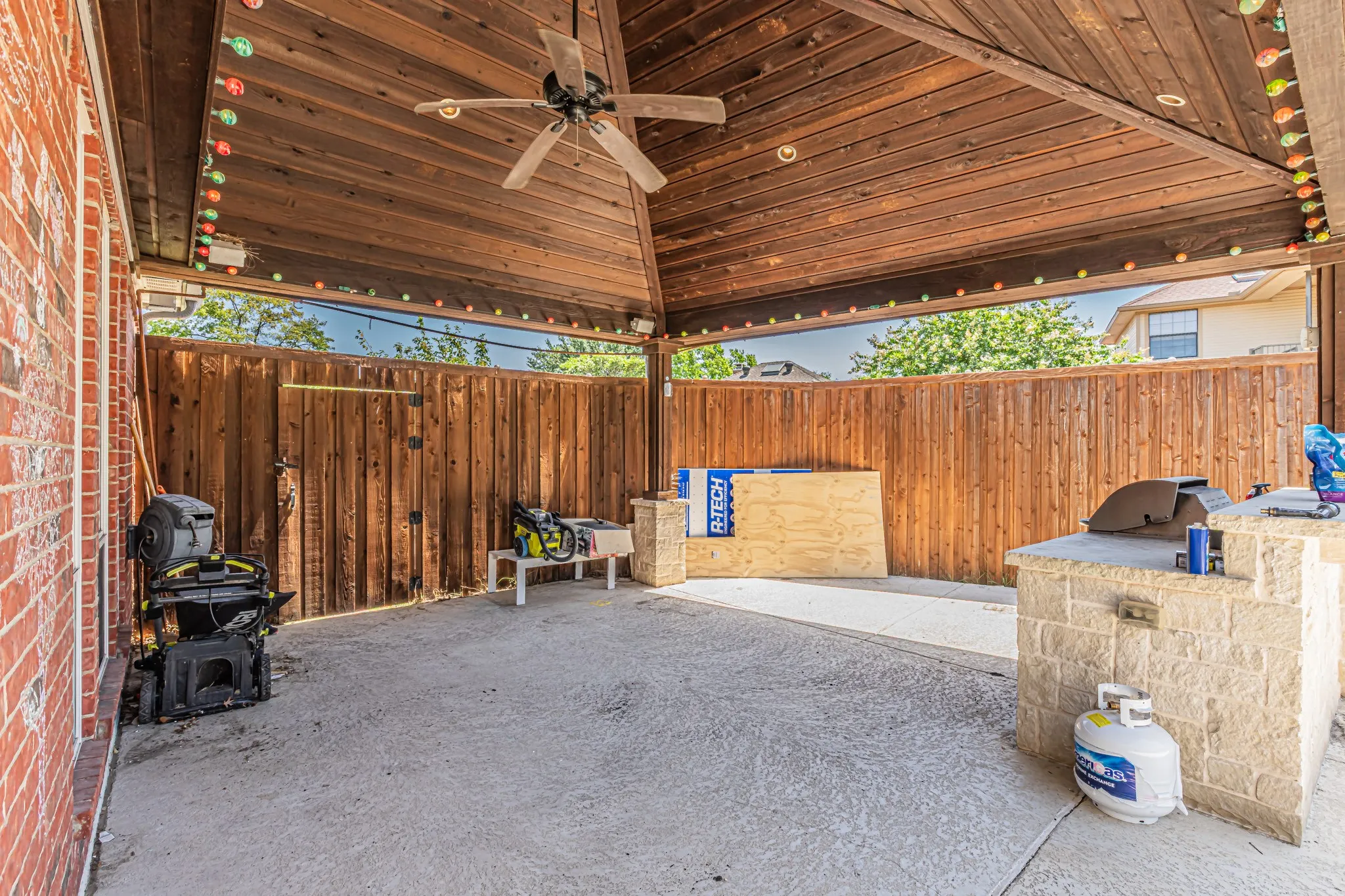 Covered patio with a wood-plank ceiling, ceiling fan, and recessed lighting